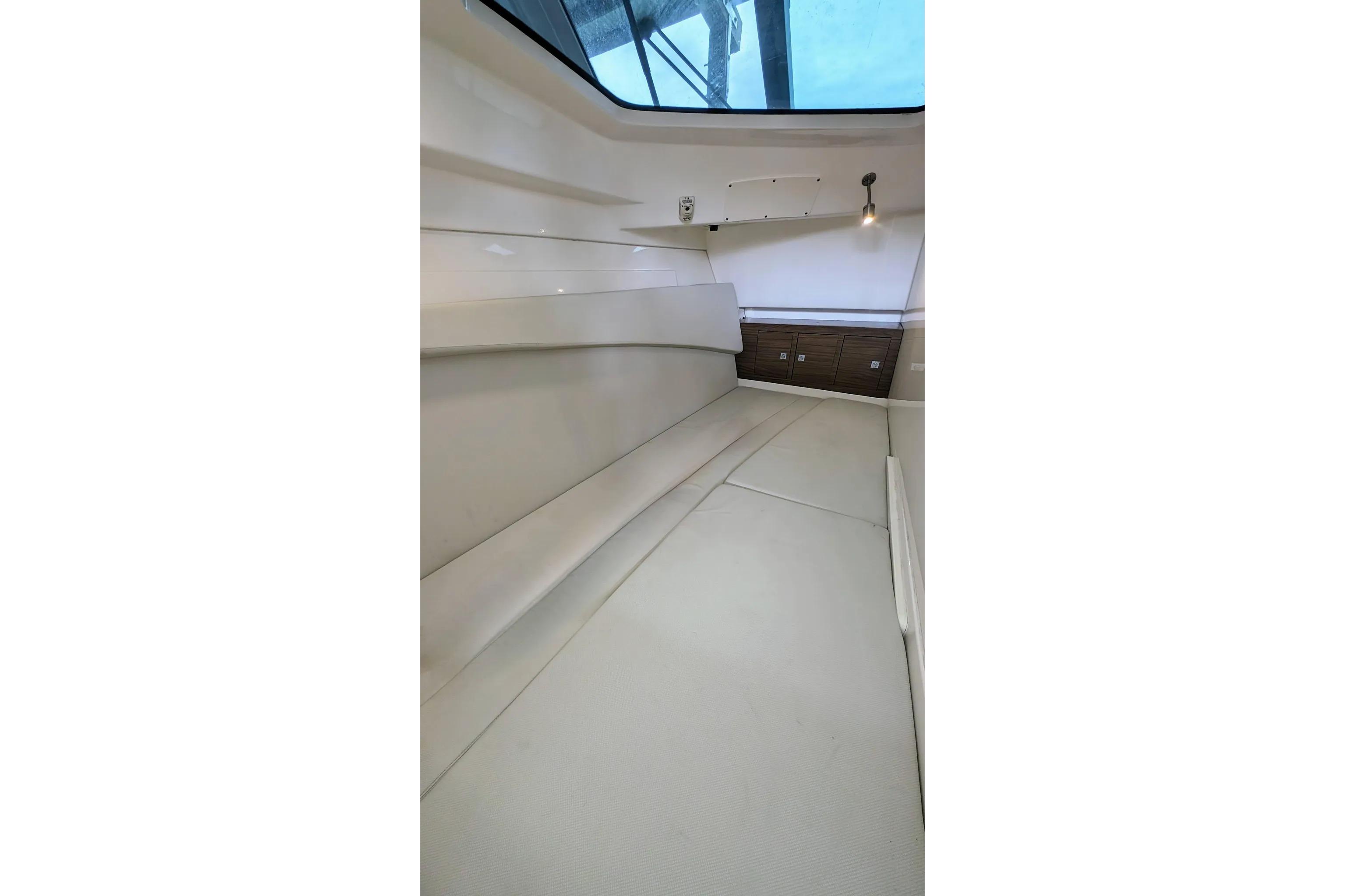 Interior cabin of 2017 Boston Whaler 320 Vantage, featuring sleek seating and storage.