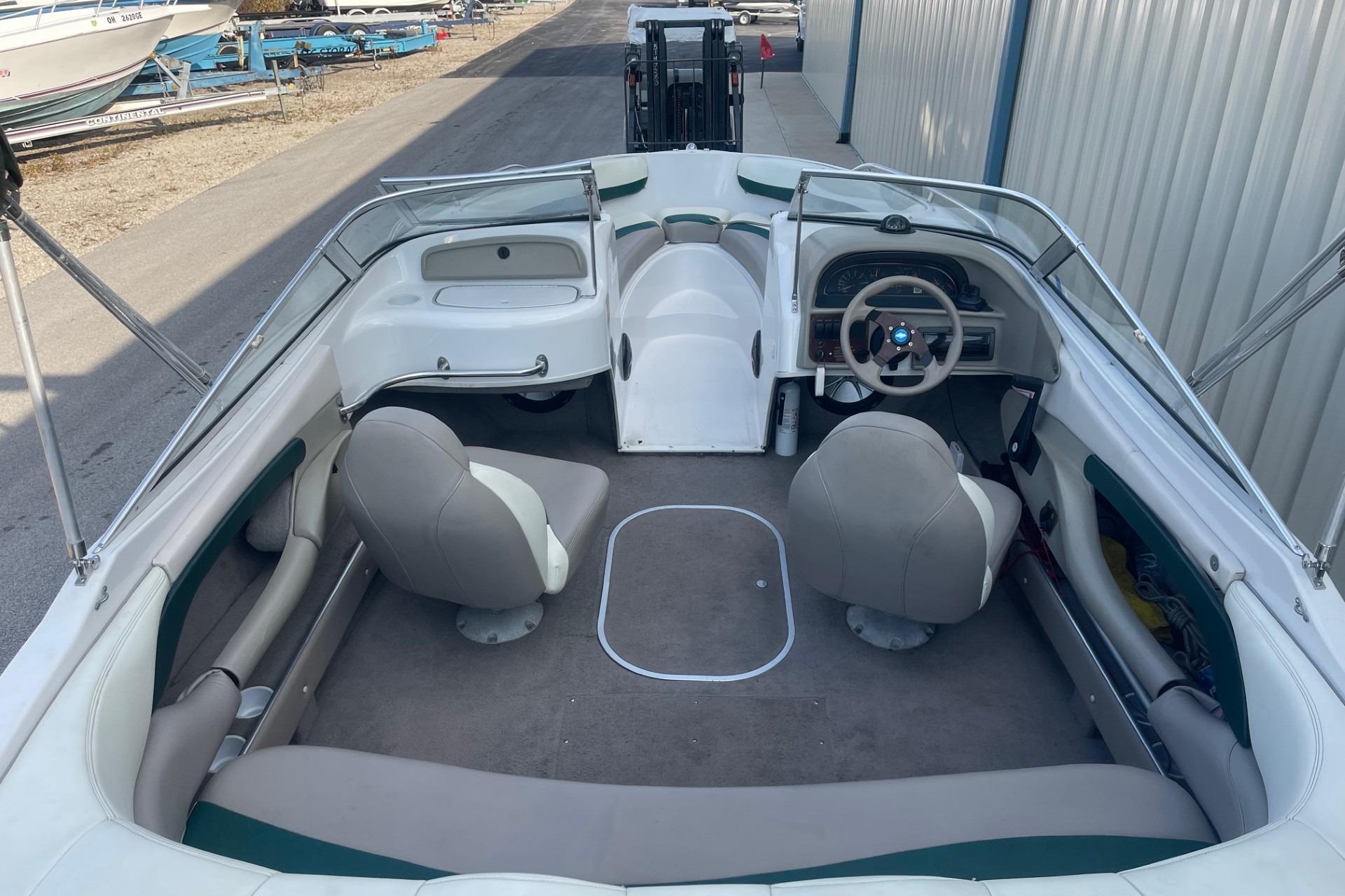 1996 Four Winns 200 Horizon boat interior with seating and steering wheel.