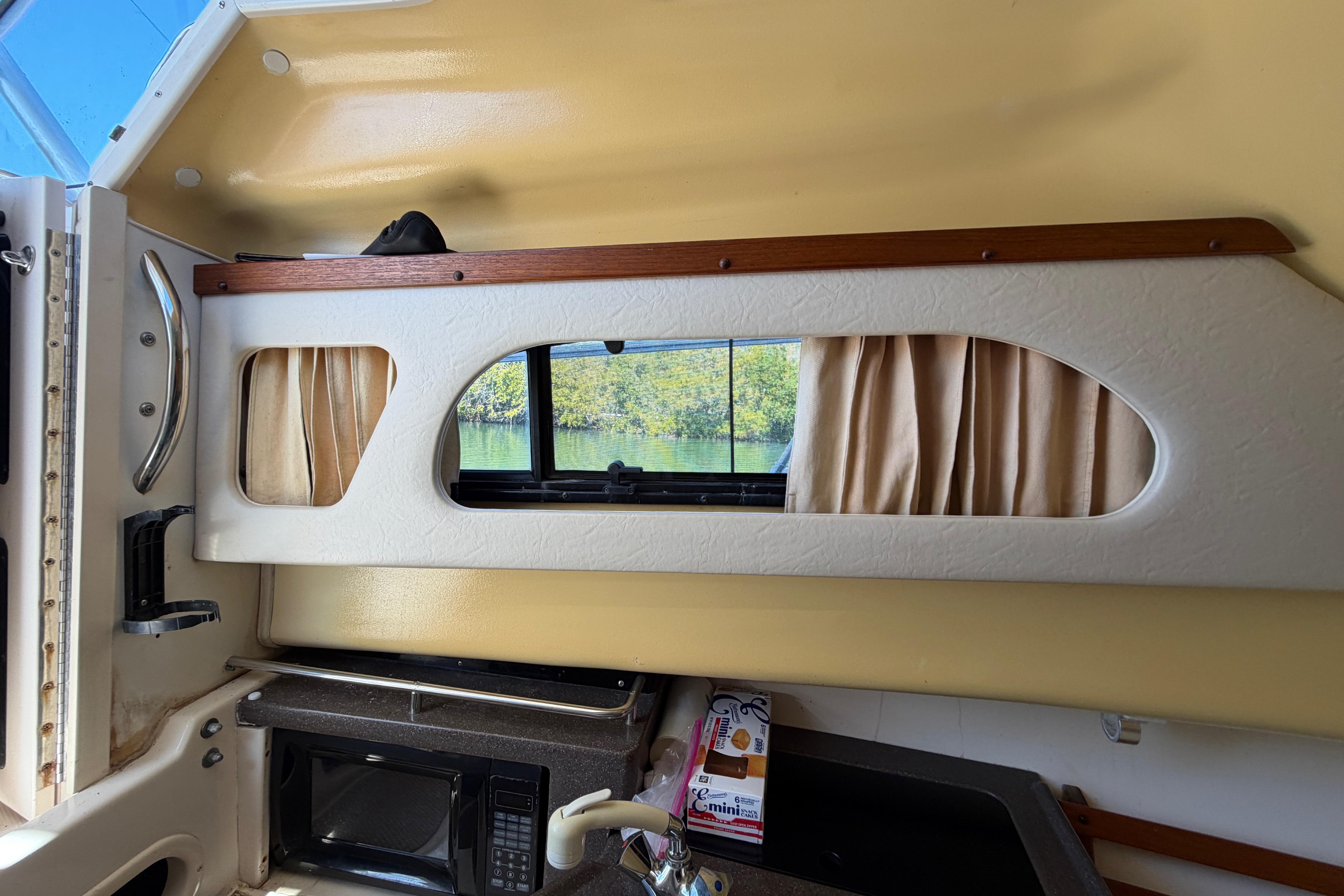 Interior of 2006 Grady-White Sailfish 282 boat with window and microwave.