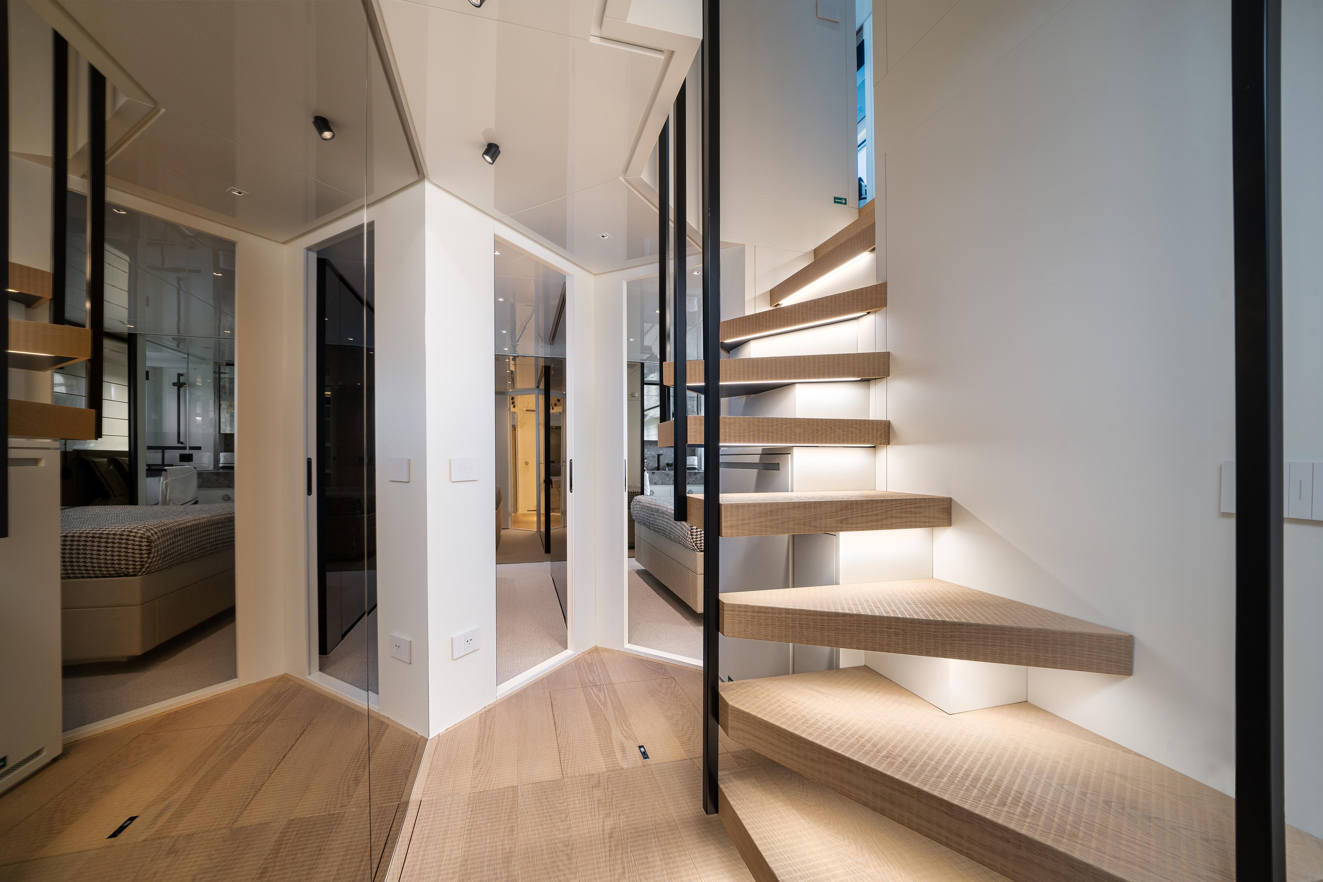 Modern interior of 2022 Sanlorenzo SL96A yacht with sleek staircase and elegant design.