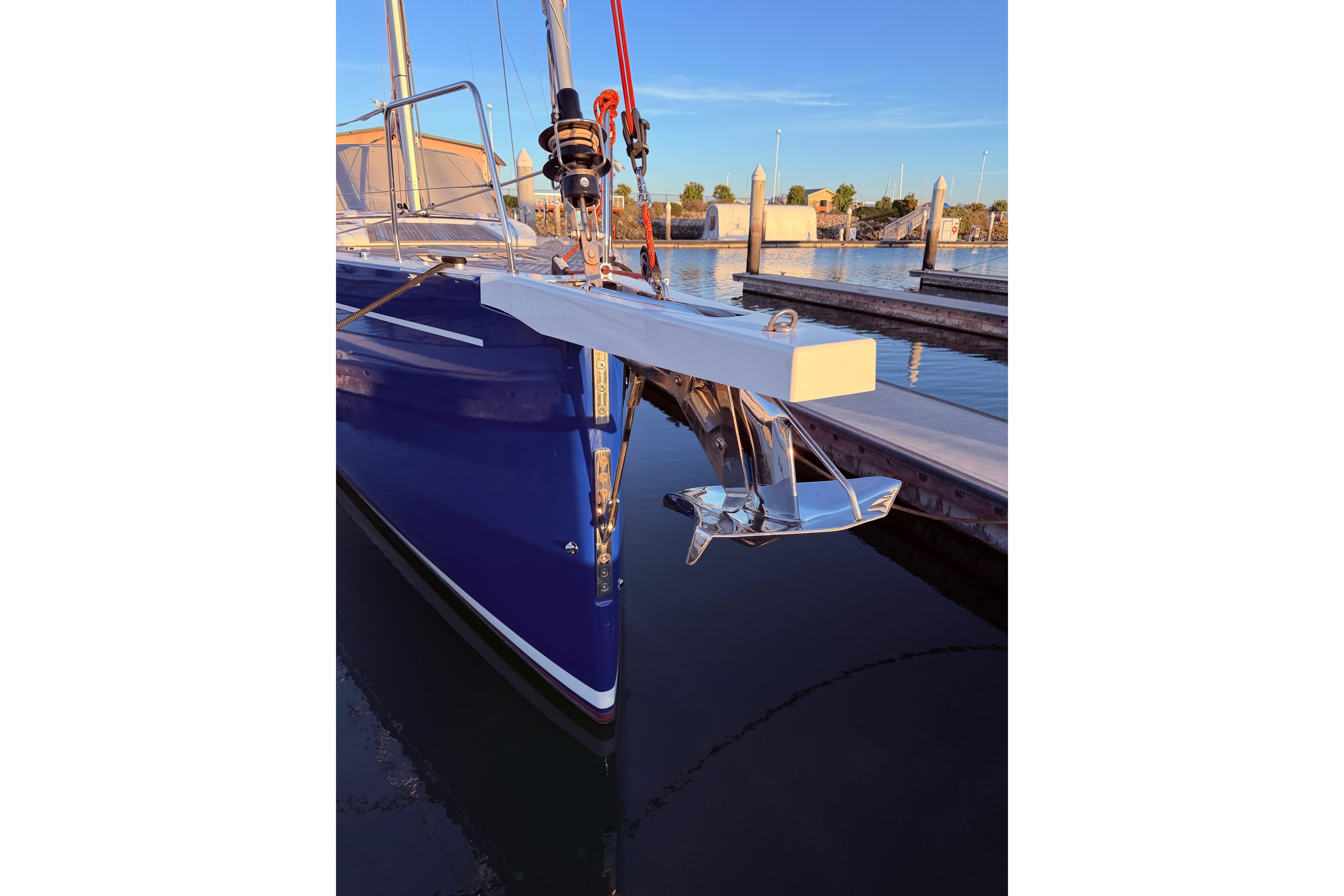 Beneteau Oceanis Yacht 54, 2022 model, docked with visible anchor and sleek blue hull.