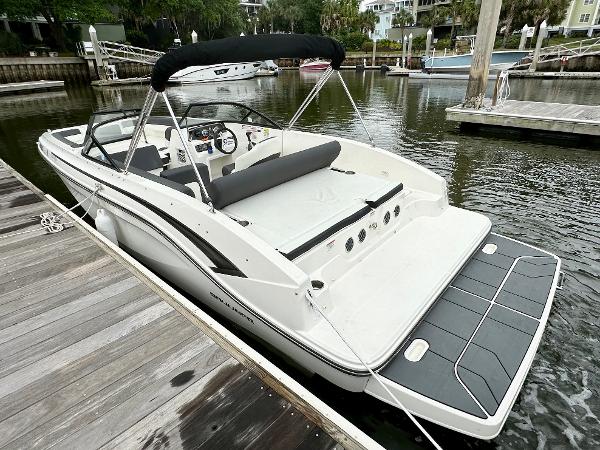 2022 Bayliner DX 2050 boat docked at a marina, featuring sleek design and spacious deck.