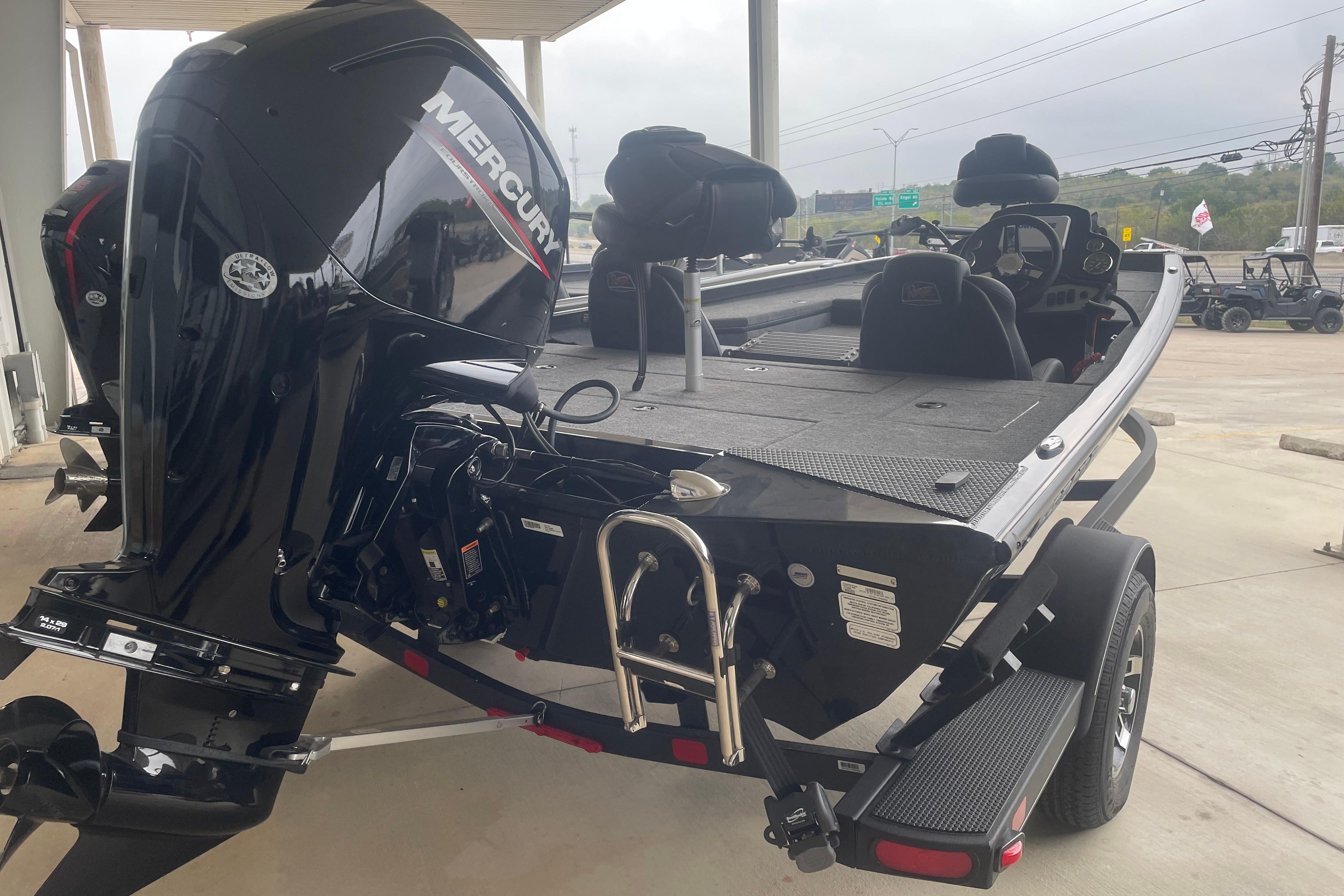2026 Ranger RT178 boat with Mercury engine, displayed on a trailer in a showroom.