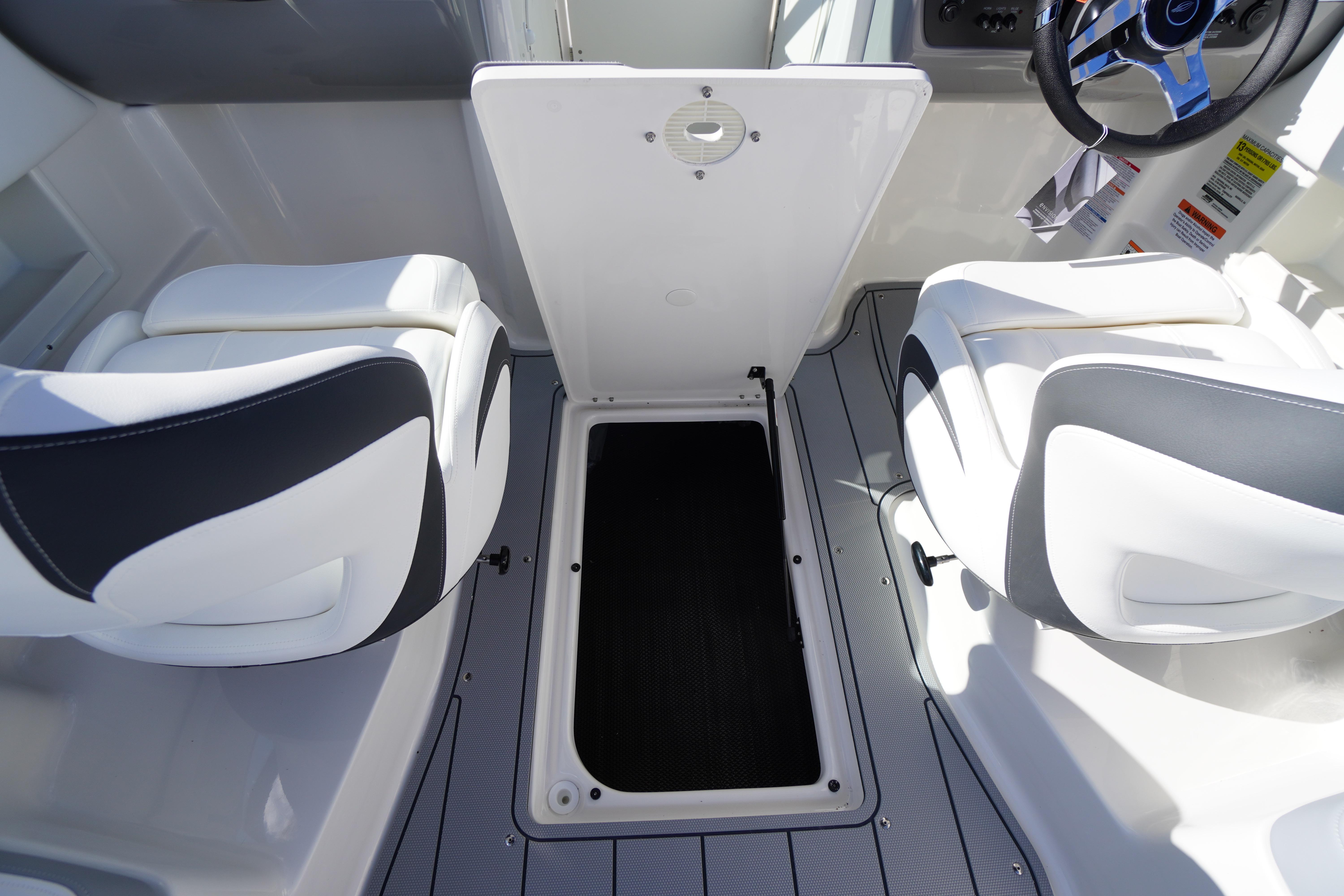 2026 Chaparral 23 SSi OB boat interior with open storage compartment and seating.
