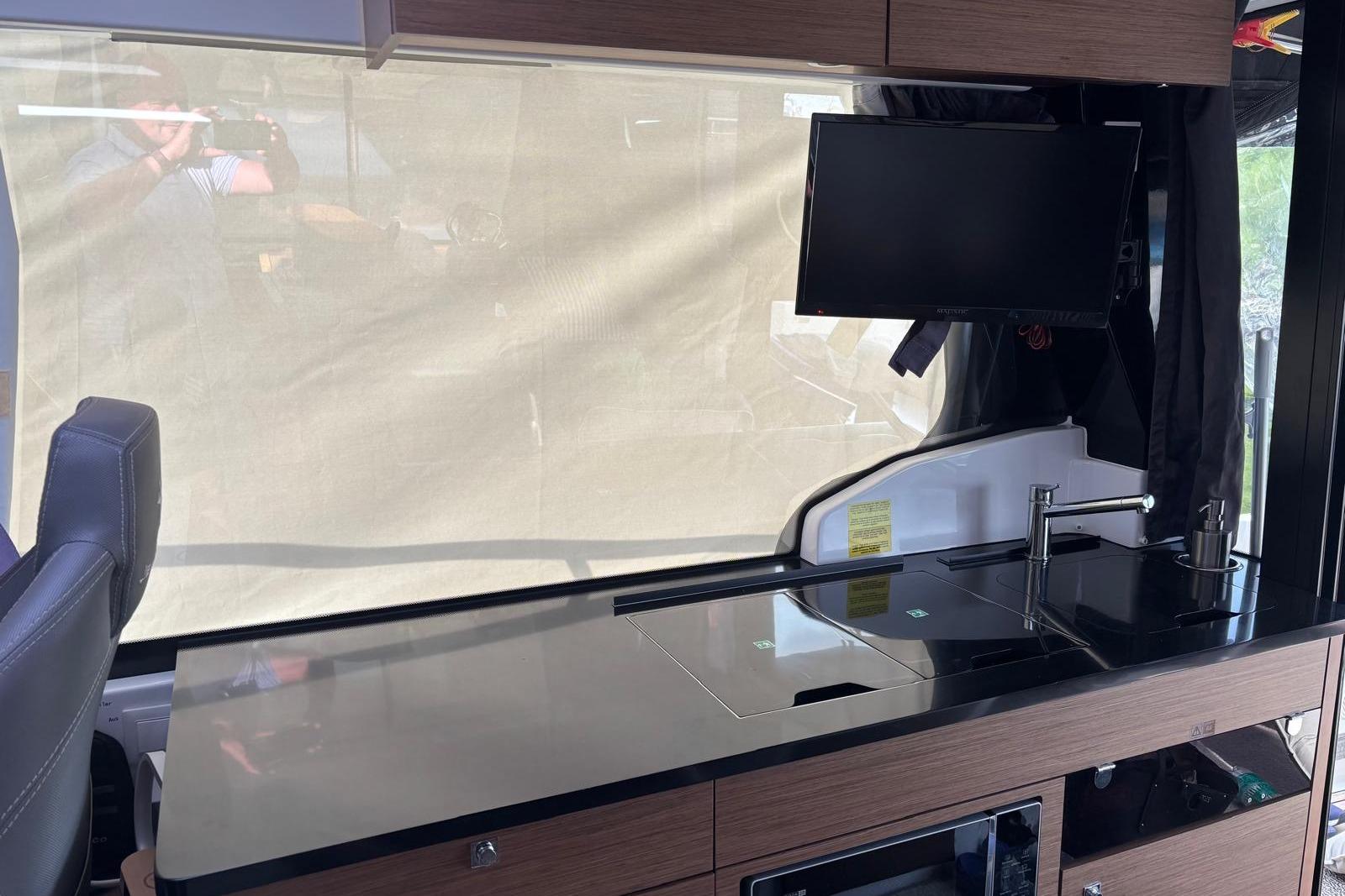 Interior of 2020 Jeanneau Merry Fisher 1095 with modern kitchen and mounted TV.