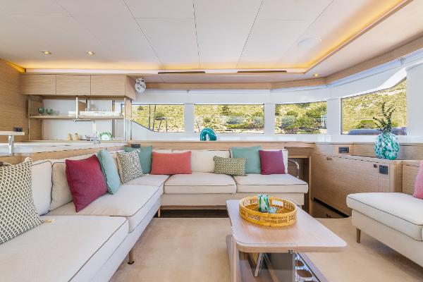 Luxurious interior of 2025 Lagoon 60 yacht with modern decor and spacious seating.