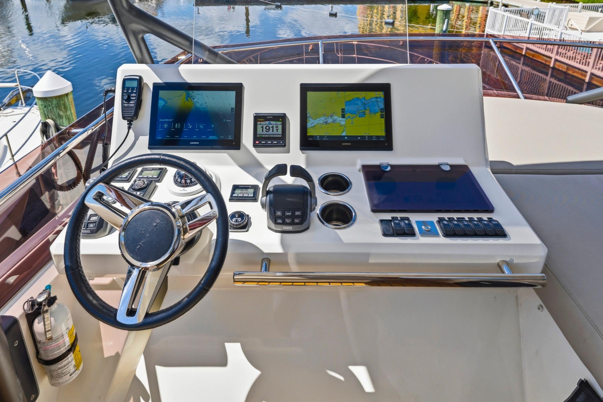 Cockpit of 2022 Prestige 520 yacht with modern navigation displays and controls.
