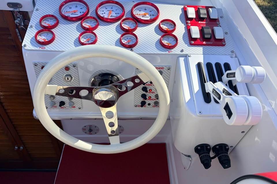 1983 Cigarette 24' Classic boat dashboard with gauges, steering wheel, and control levers.