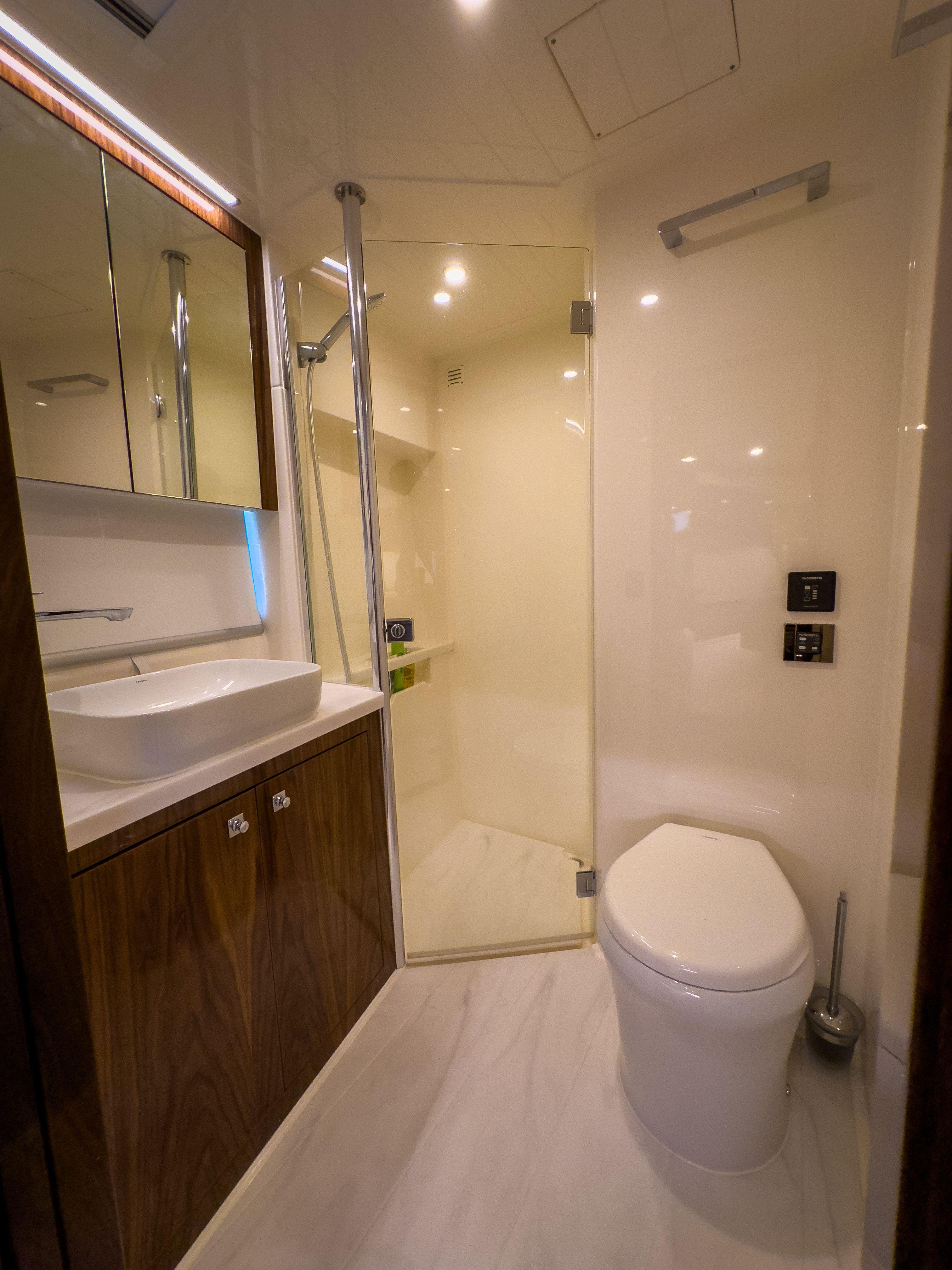 Luxurious bathroom in 2024 Riviera 465 SUV yacht with modern fixtures and elegant design.