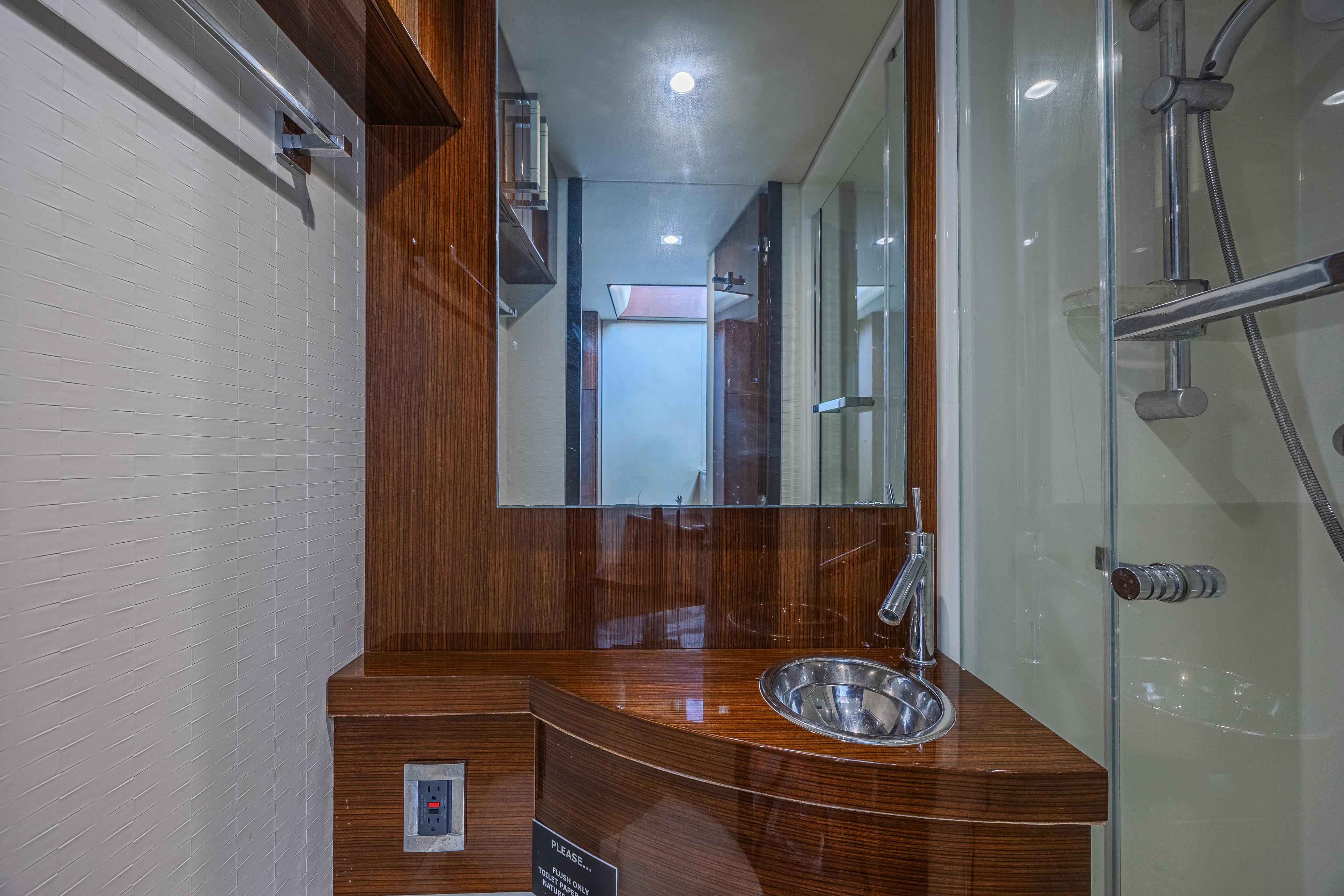 Luxurious bathroom interior of 2010 Lazzara LSX 92 yacht with modern fixtures.
