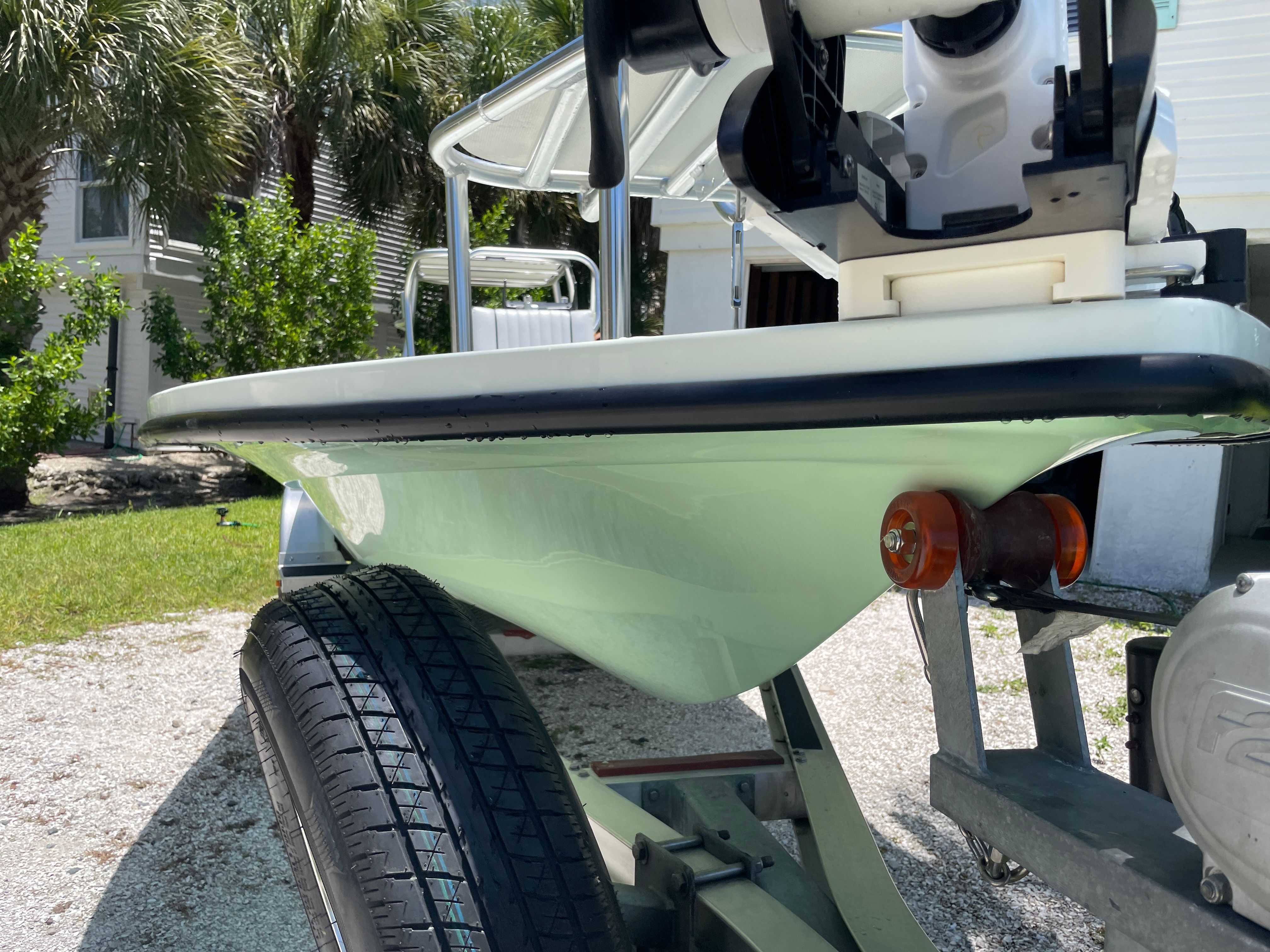 Close-up of a boat trailer with a Beavertail Skiffs Mosquito boat on it.