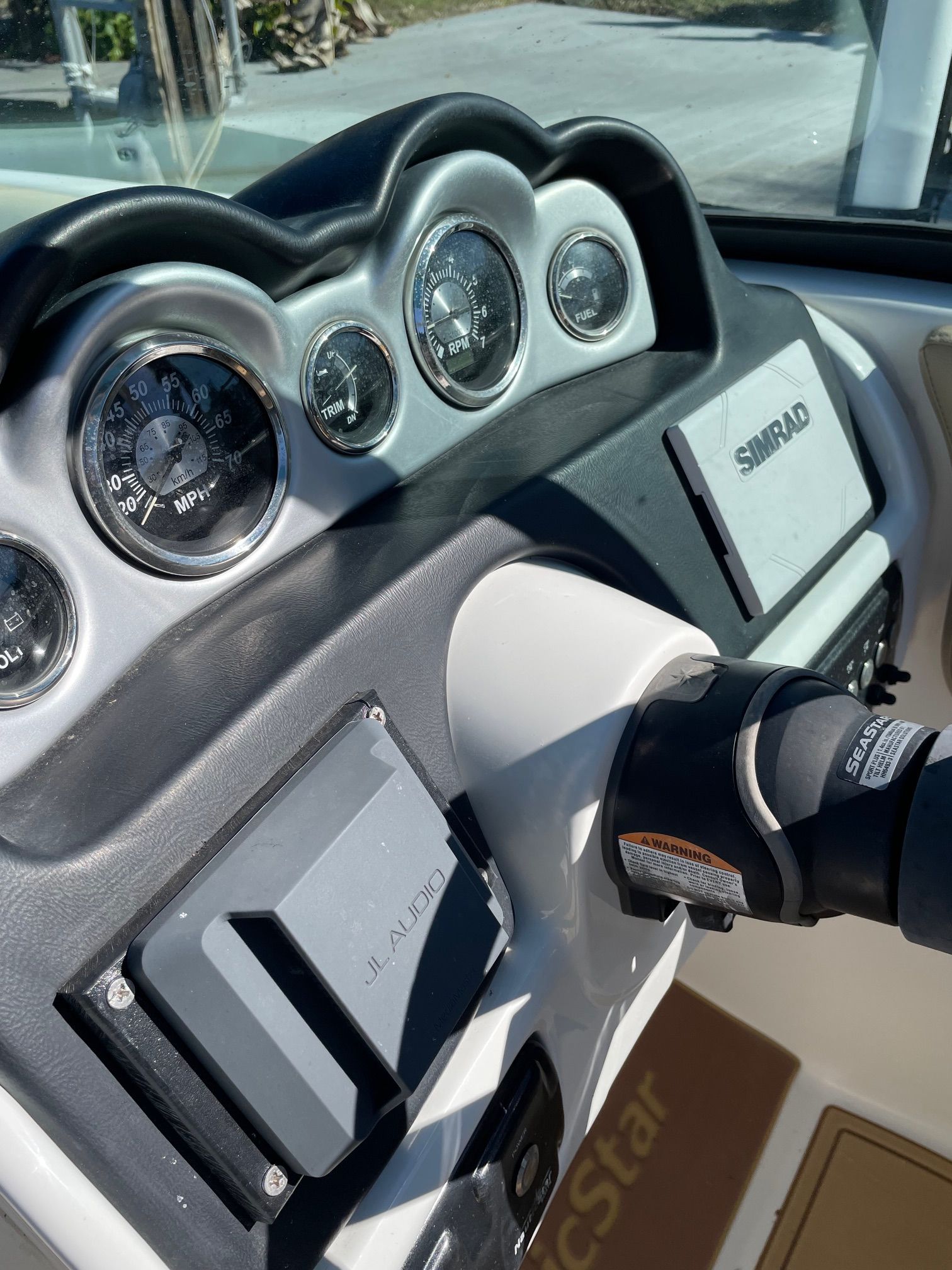 Dashboard of a 2019 NauticStar 243DC Sport Deck with speedometer and Simrad display.