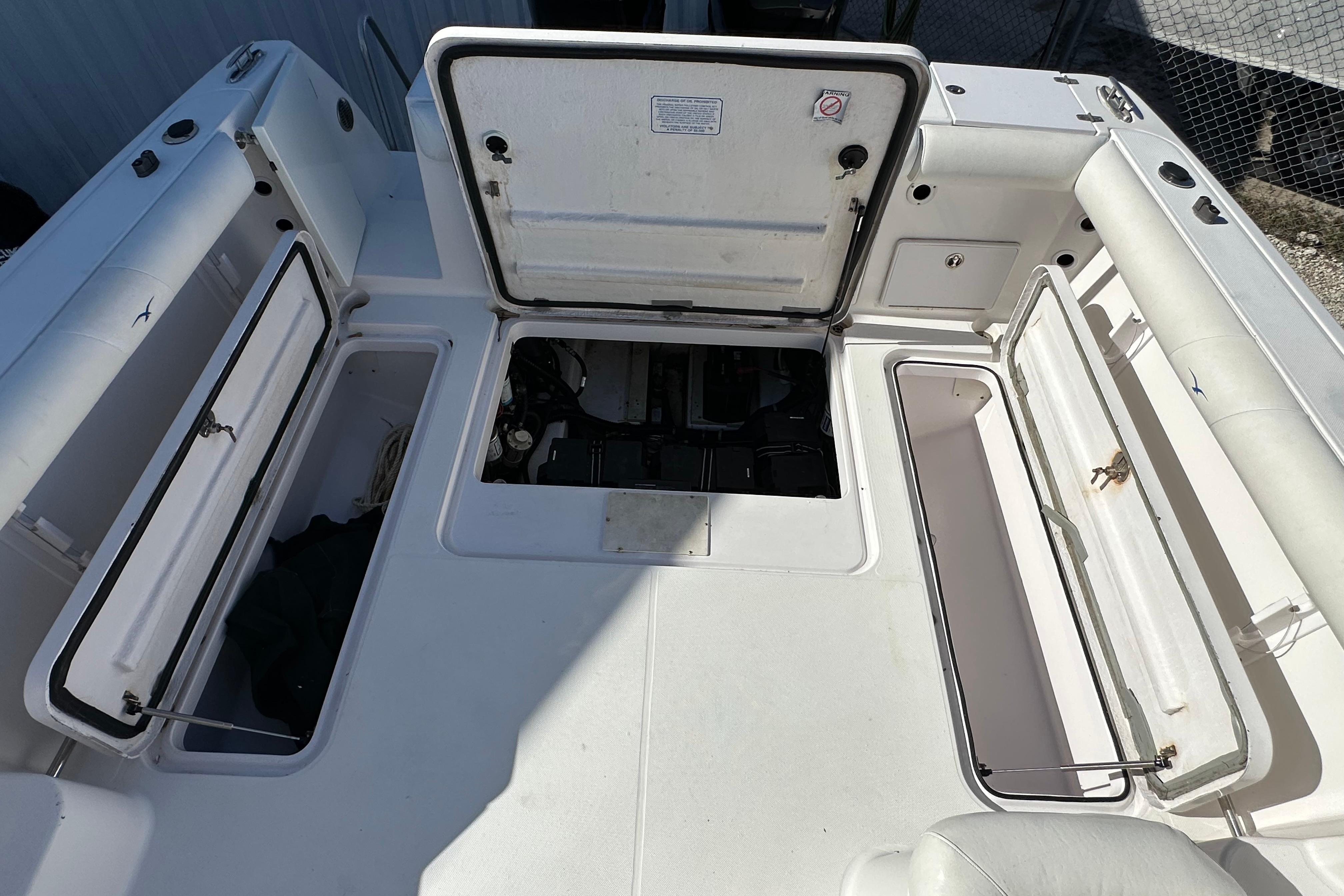 Open storage compartments on a 2006 Pro-Line 32 Express boat deck.