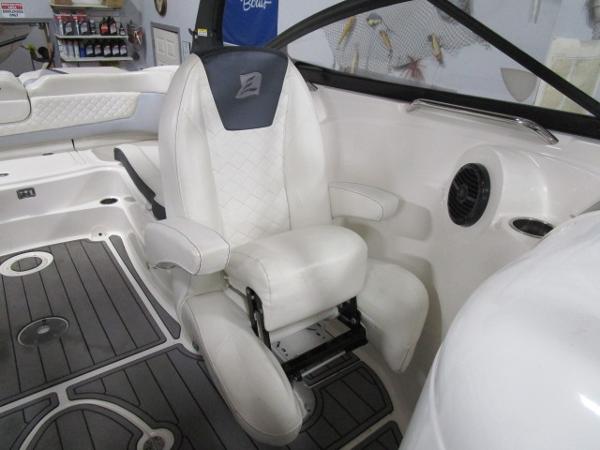 2017 Larson 292 LXI boat interior with white captain's chair and sleek design.