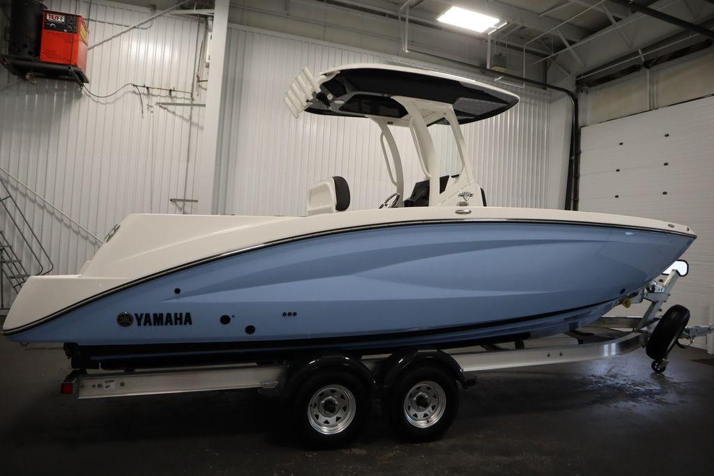 2026 Yamaha Boats 255 FSH Sport E in a garage, side view on trailer.