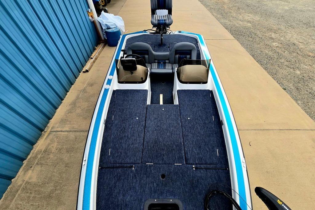 1996 Champion 181 SX boat with blue interior, parked beside a blue building.