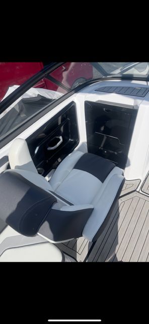 Interior of a 2021 Yamaha 212S boat with seat and helm console.