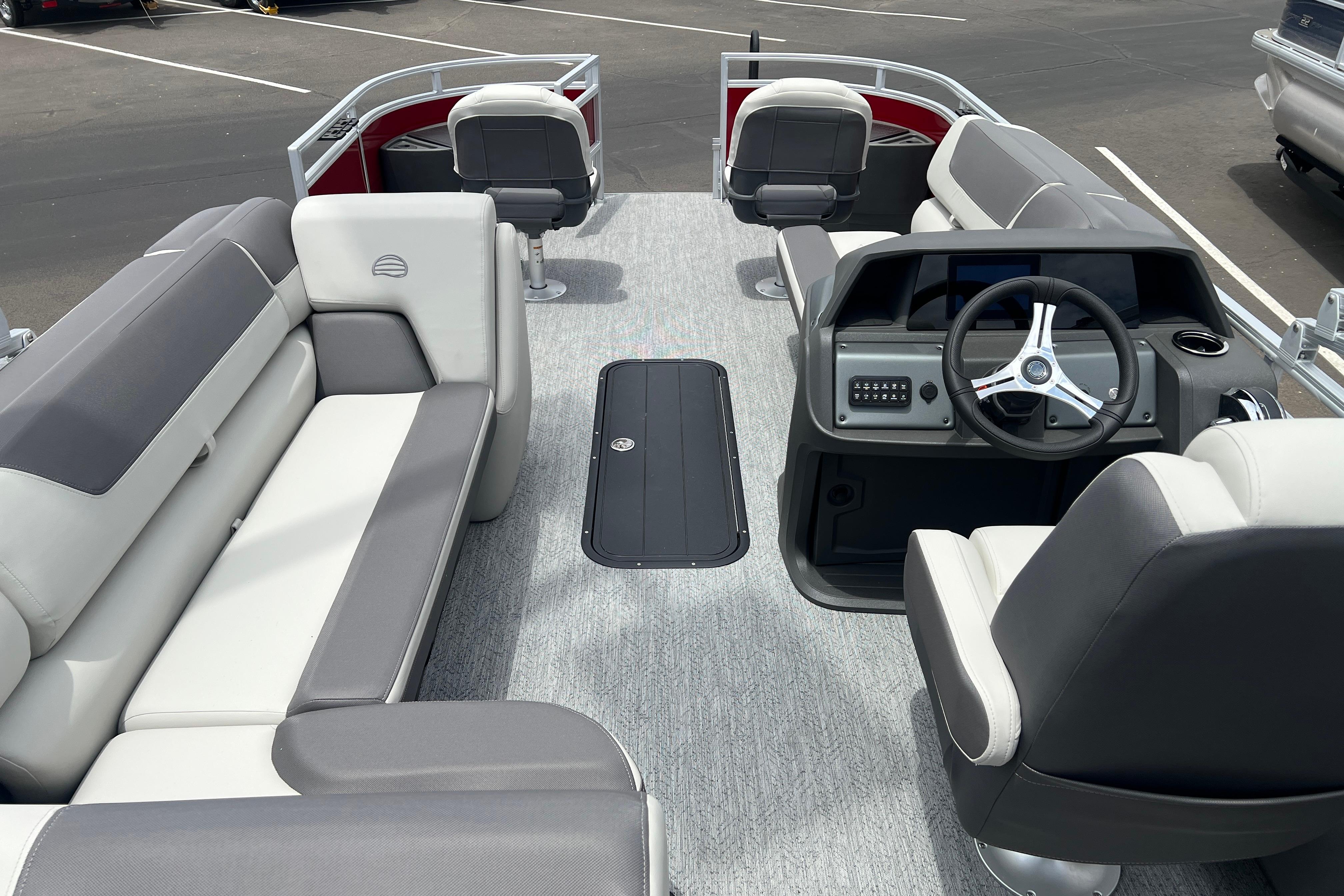 2026 Sun Tracker Fishin' Barge 22 XP3 interior with seating and steering console.