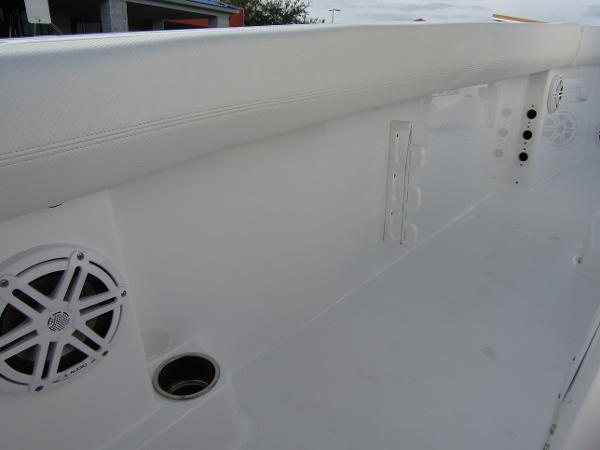 2025 Wellcraft 243 Fisherman boat interior with speakers and cup holder.