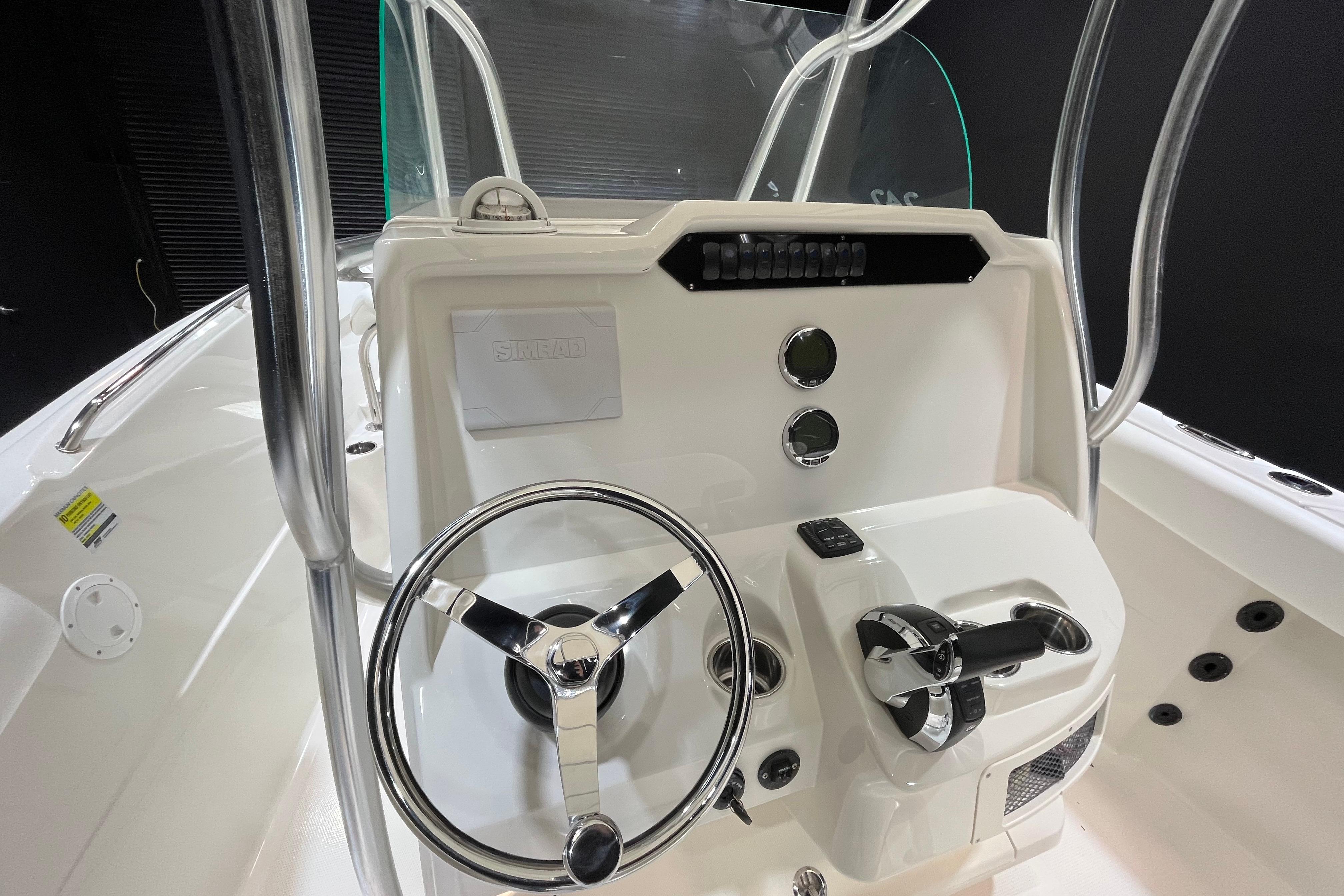 2022 Sailfish 242 CC boat console with steering wheel and controls.