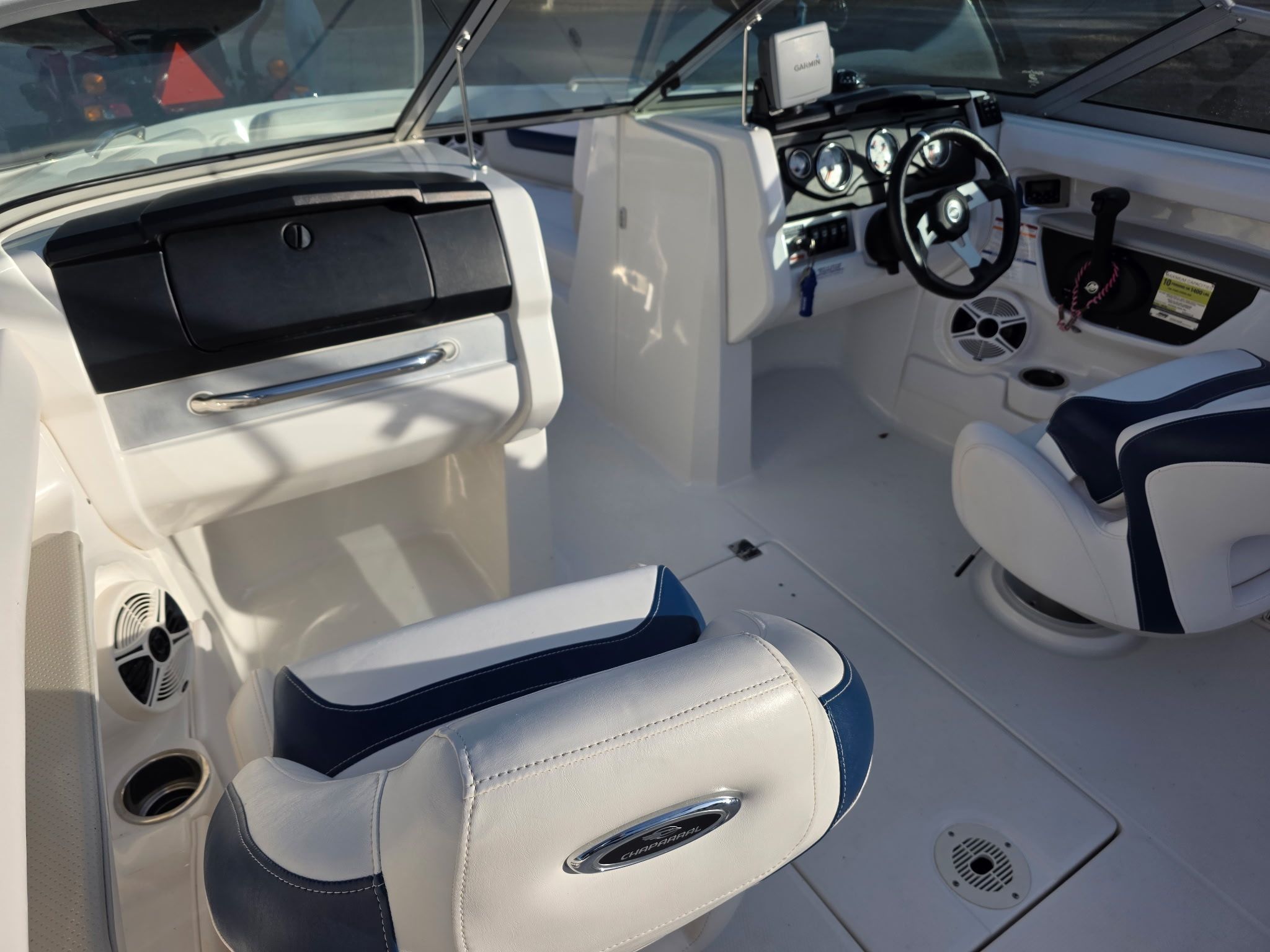 Interior of a Chaparral 206 SSi boat with white and blue seating.