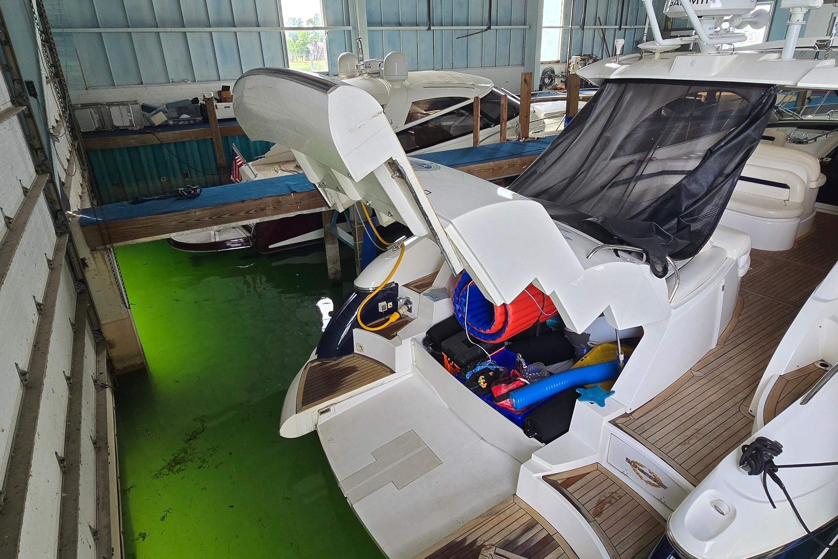 2004 Sunseeker Camargue 50 yacht docked indoors with open storage compartment.