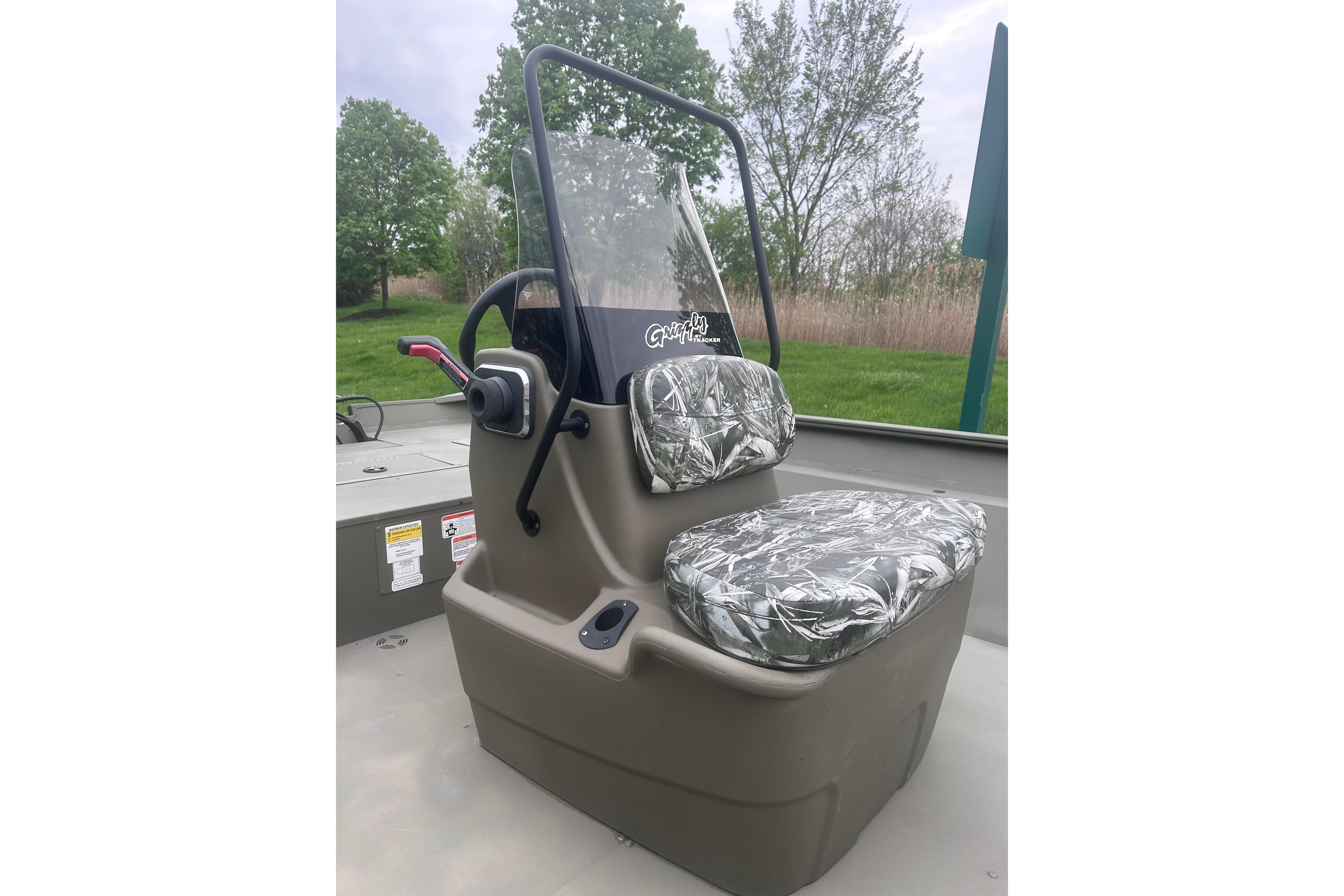 2024 Tracker Grizzly 2072 CC boat console with camouflage seat covers.
