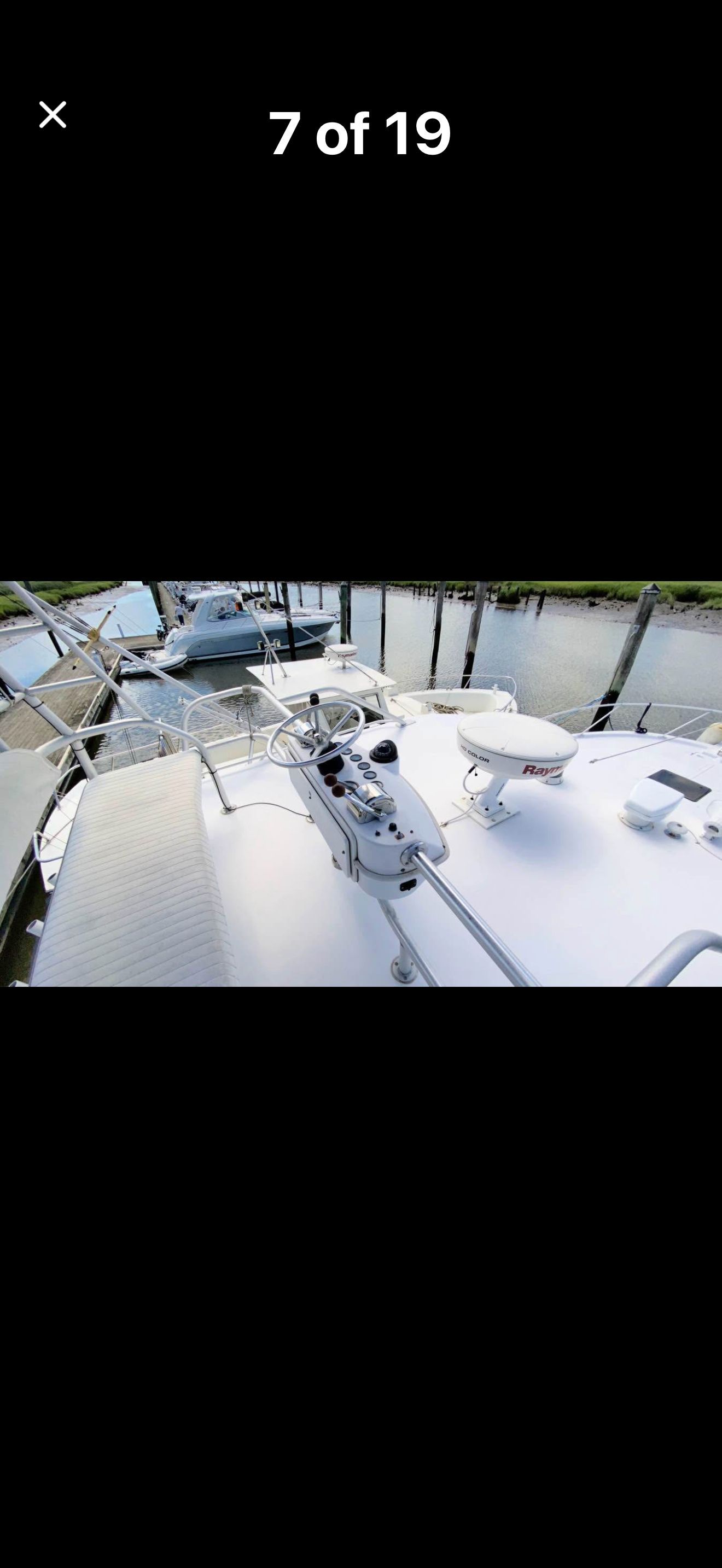The image shows the deck of a 1999 Luhrs Sx36 boat at a dock.
