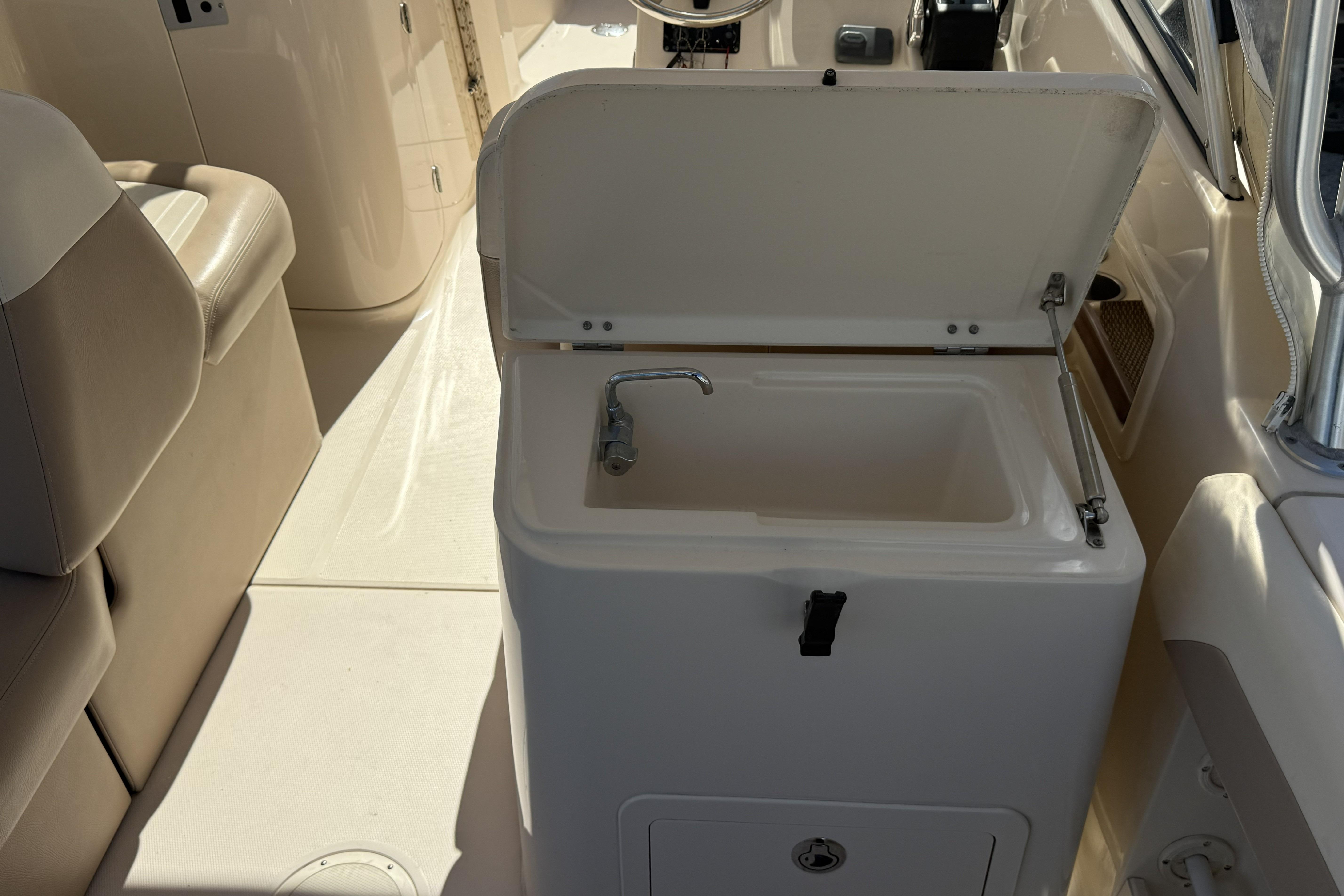 2014 Grady-White Freedom 275 boat interior with sink and seating area.