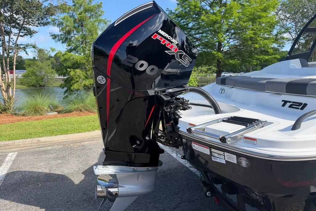 2026 Tahoe T21 boat with Mercury Pro XS 200 engine, parked near a scenic lake.