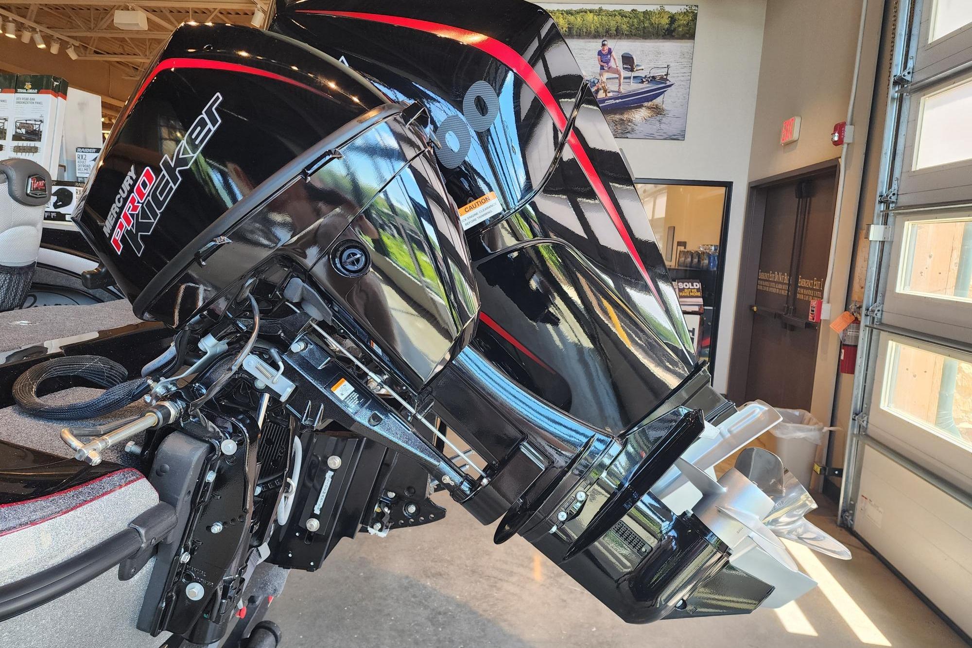 2025 Ranger 1880MS boat with Mercury Pro Kicker outboard motor in showroom.