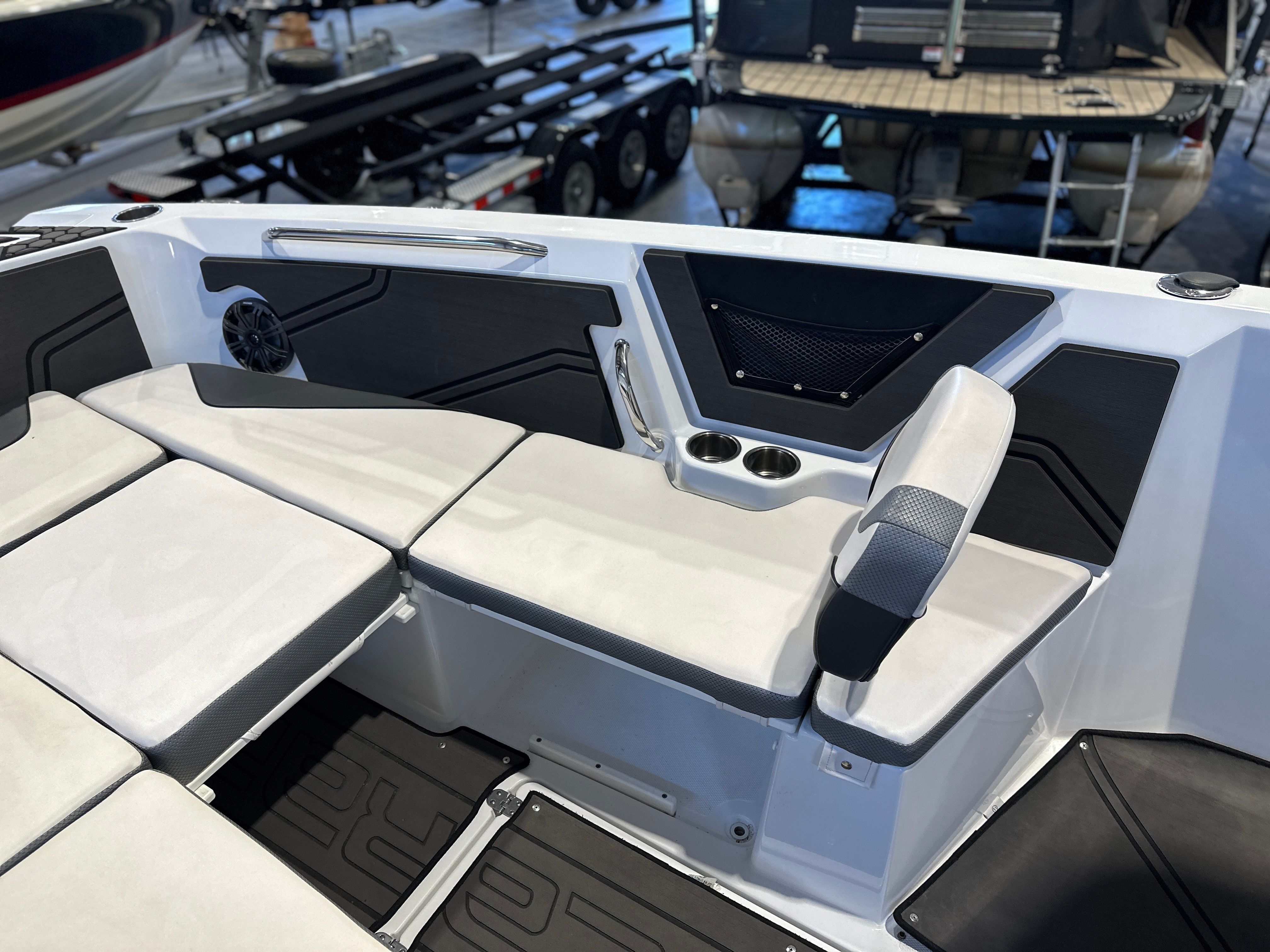 The image shows the interior of a 2021 Scarab 255 Open ID boat with seating and speakers.