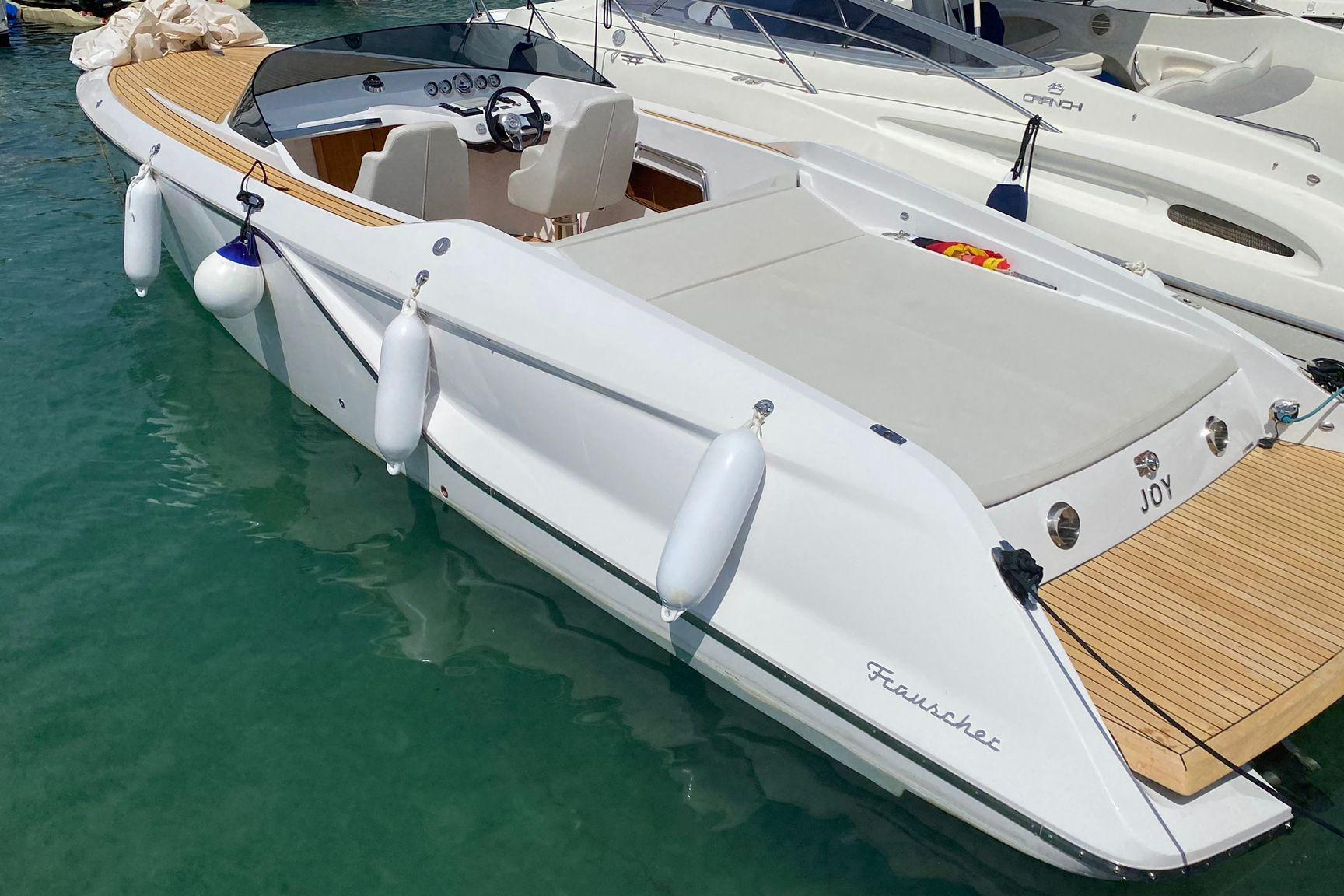 2021 Frauscher 858 Fantom boat docked in clear water, showcasing sleek design.