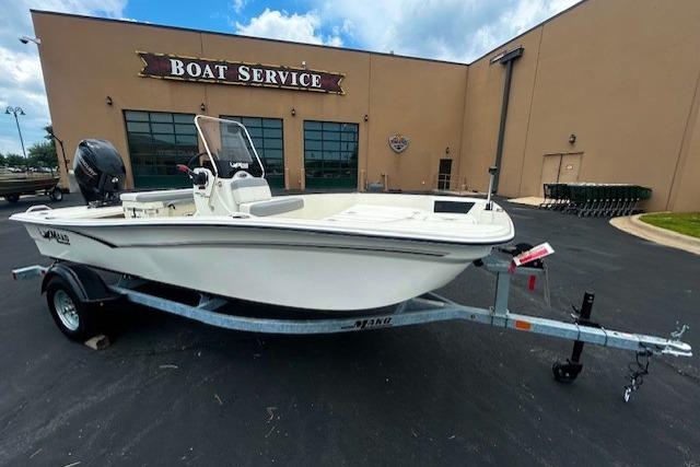 2026 Mako Pro Skiff 15 CC boat on trailer outside service center.