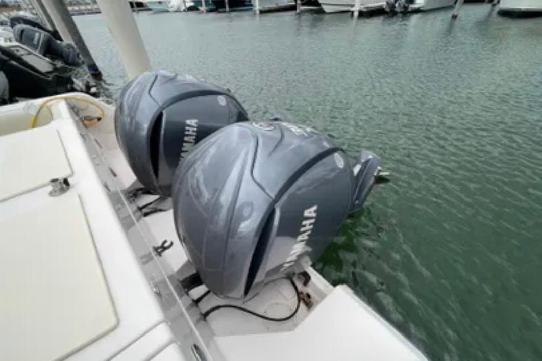 Twin Yamaha outboard engines on a 2007 Grady-White Express 330 boat docked in marina.