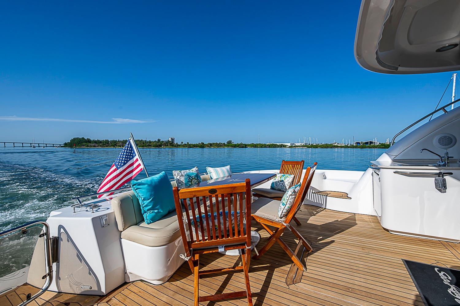 2008 Sea Ray 60 Sundancer yacht deck with seating, American flag, and ocean view.