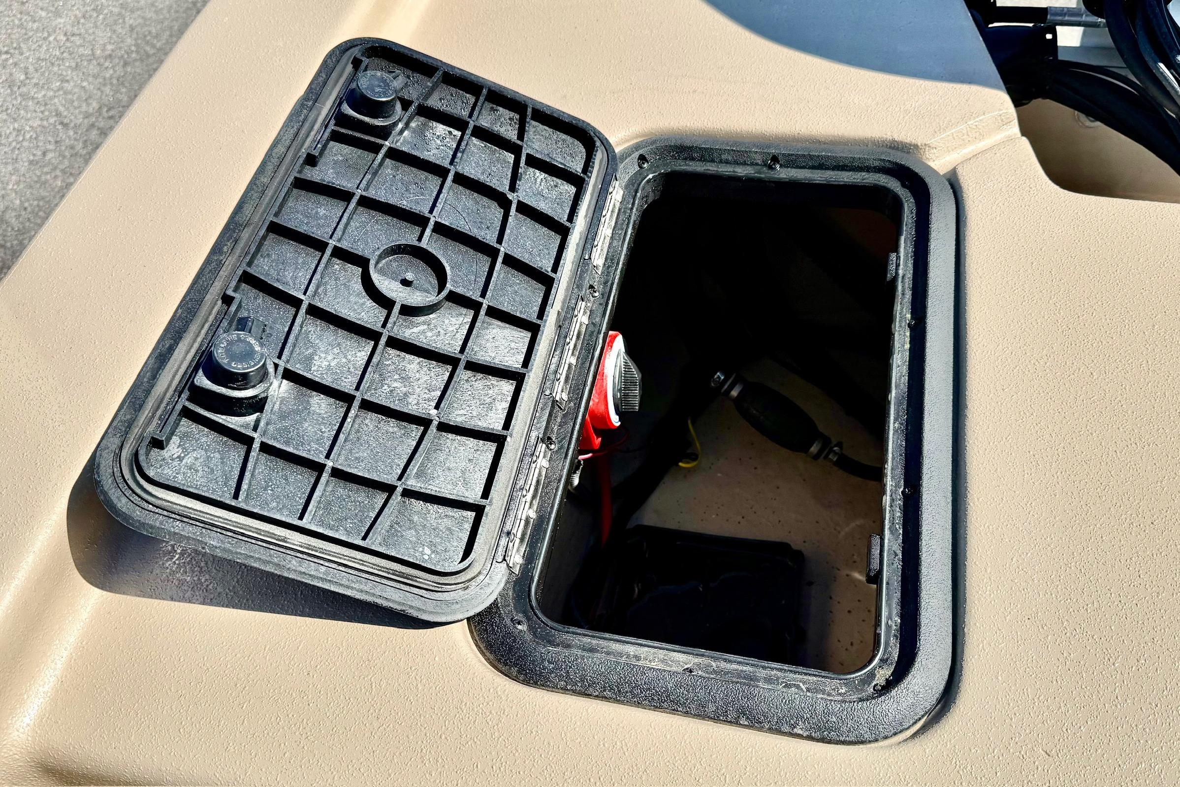 Open storage compartment on 2026 Carolina Skiff E18 JVX CC boat.