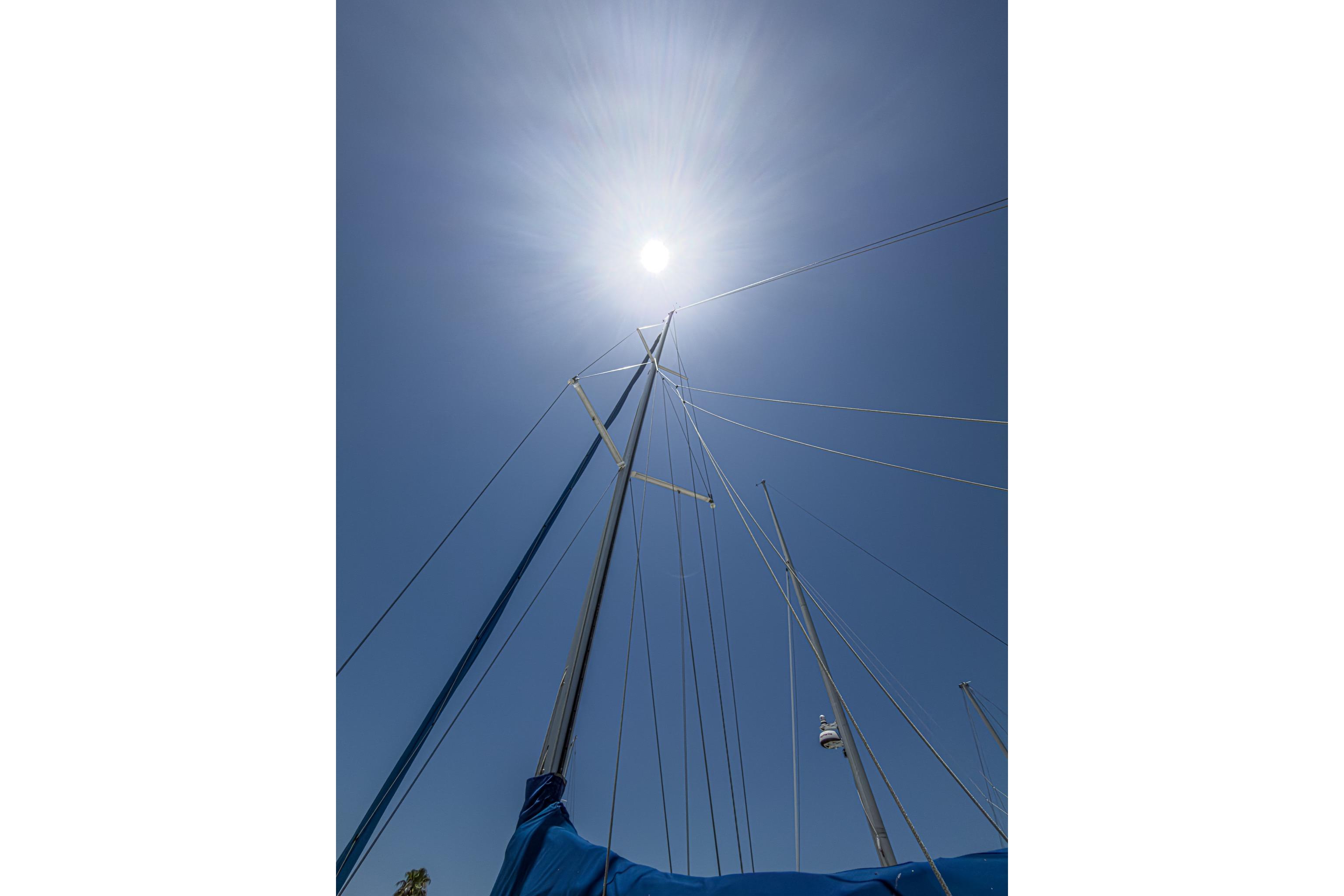 Sailboat mast of 1993 Beneteau First 38 s5 under bright sun and clear sky.