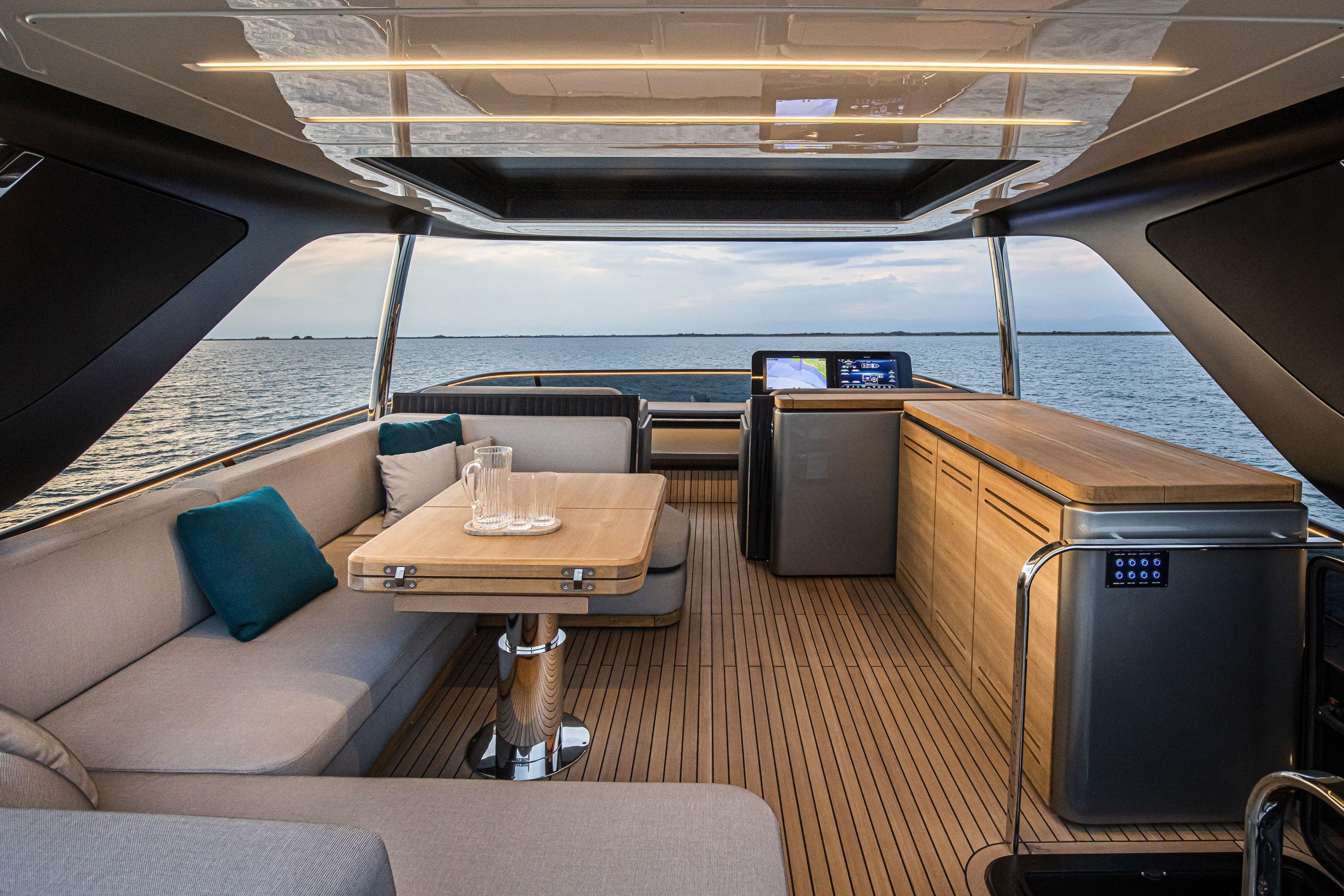 Luxurious interior of 2026 Cranchi Sessantasette 67 yacht with elegant seating and ocean view.