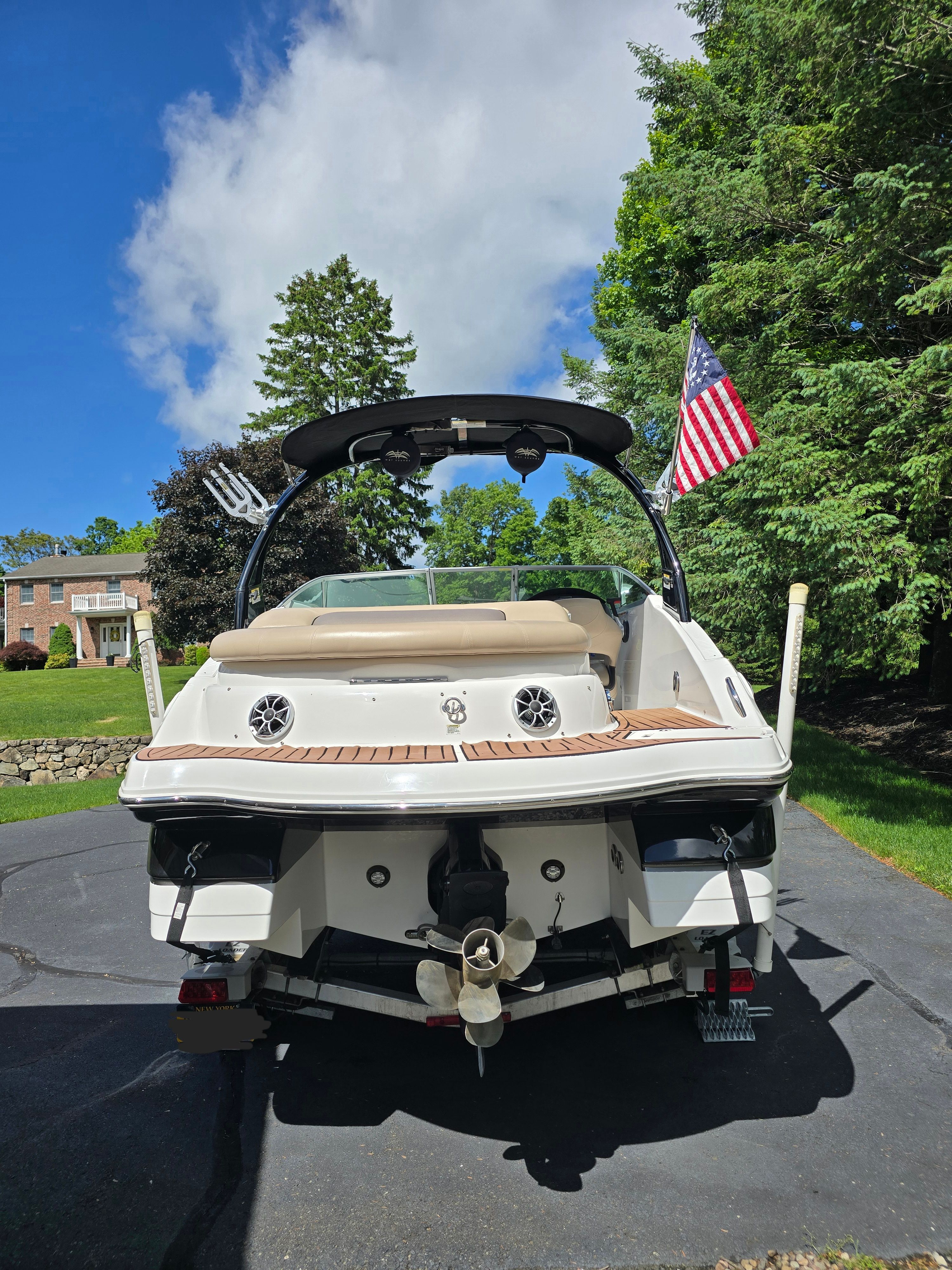2016 Hurricane SD 2200 boat on driveway with flag.