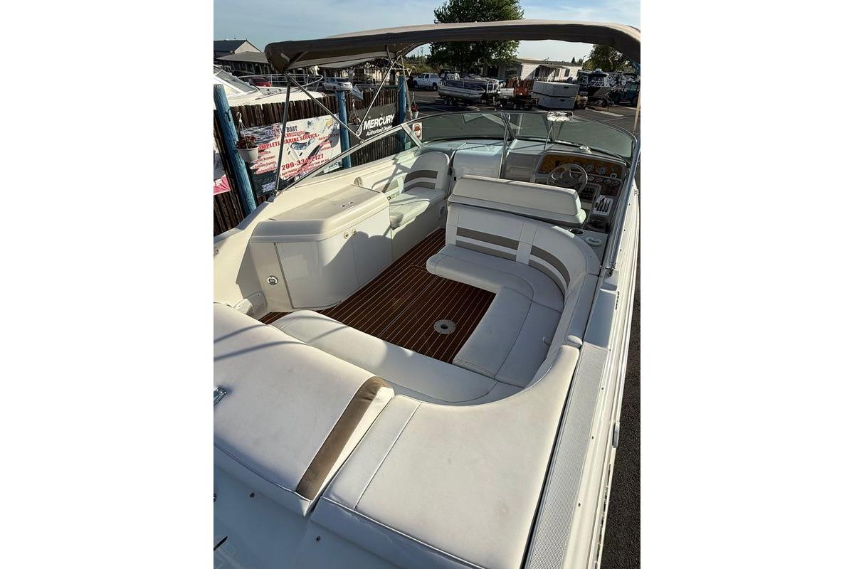 1999 Formula 280 Sun Sport boat interior with white seating and wood flooring.