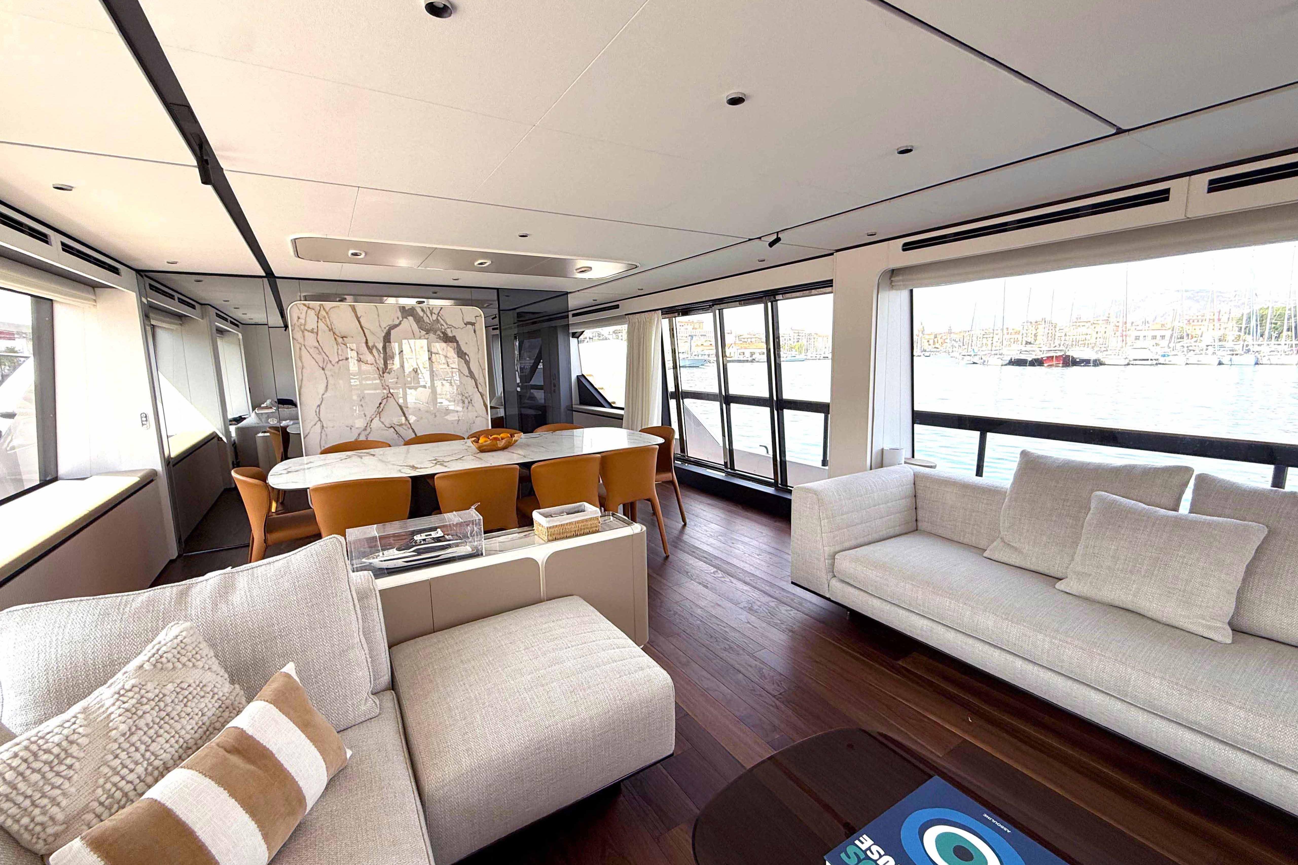 Luxurious interior of 2025 Ferretti Yachts 940 with elegant seating and dining area.
