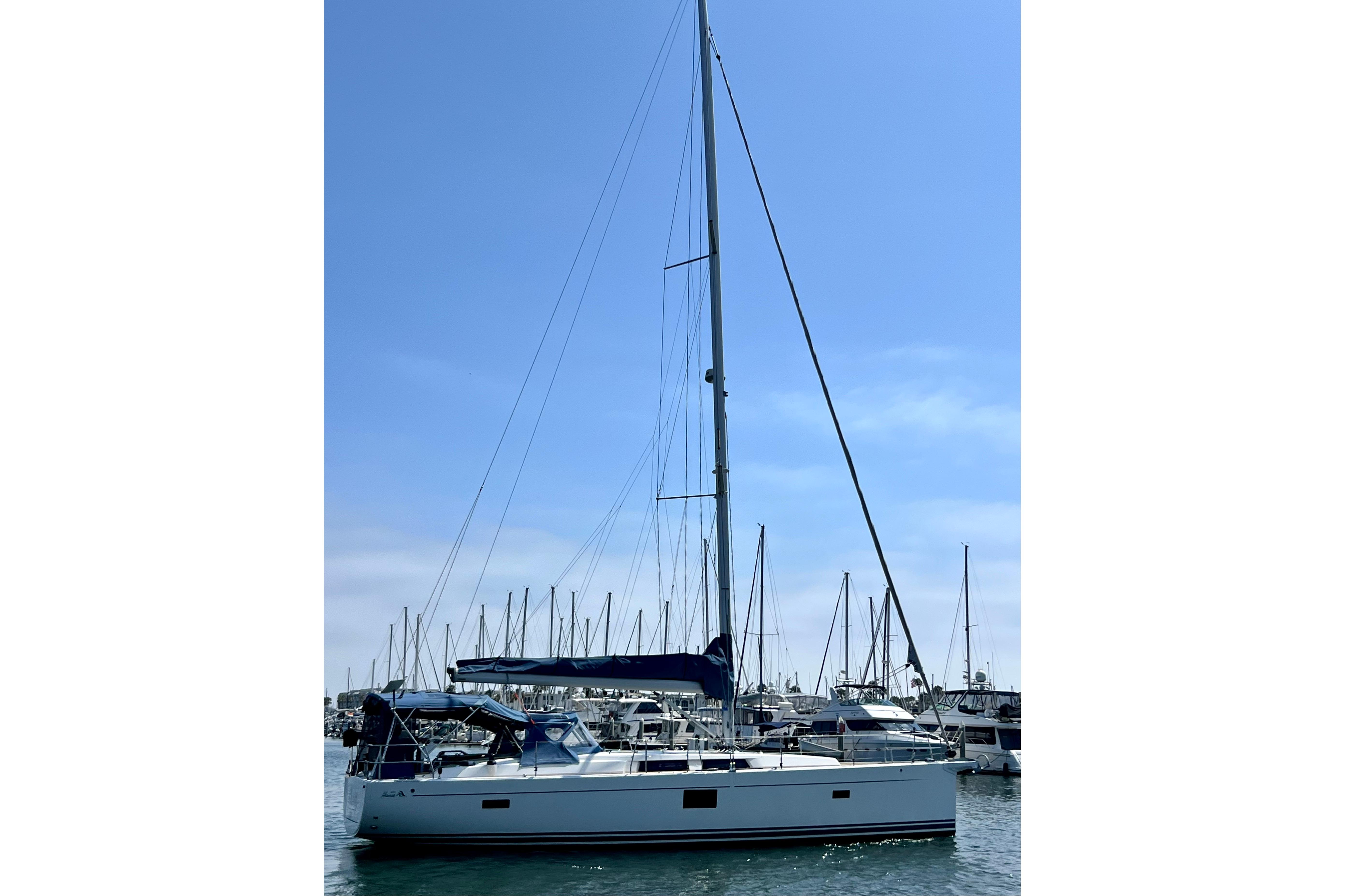 2016 Hanse 455 sailboat docked in a marina under a clear blue sky.