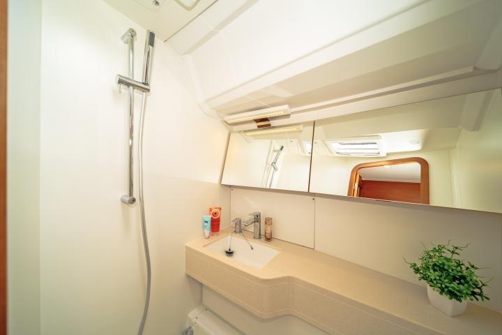 Modern bathroom interior on 2025 Dufour 44 yacht, featuring sleek design and amenities.