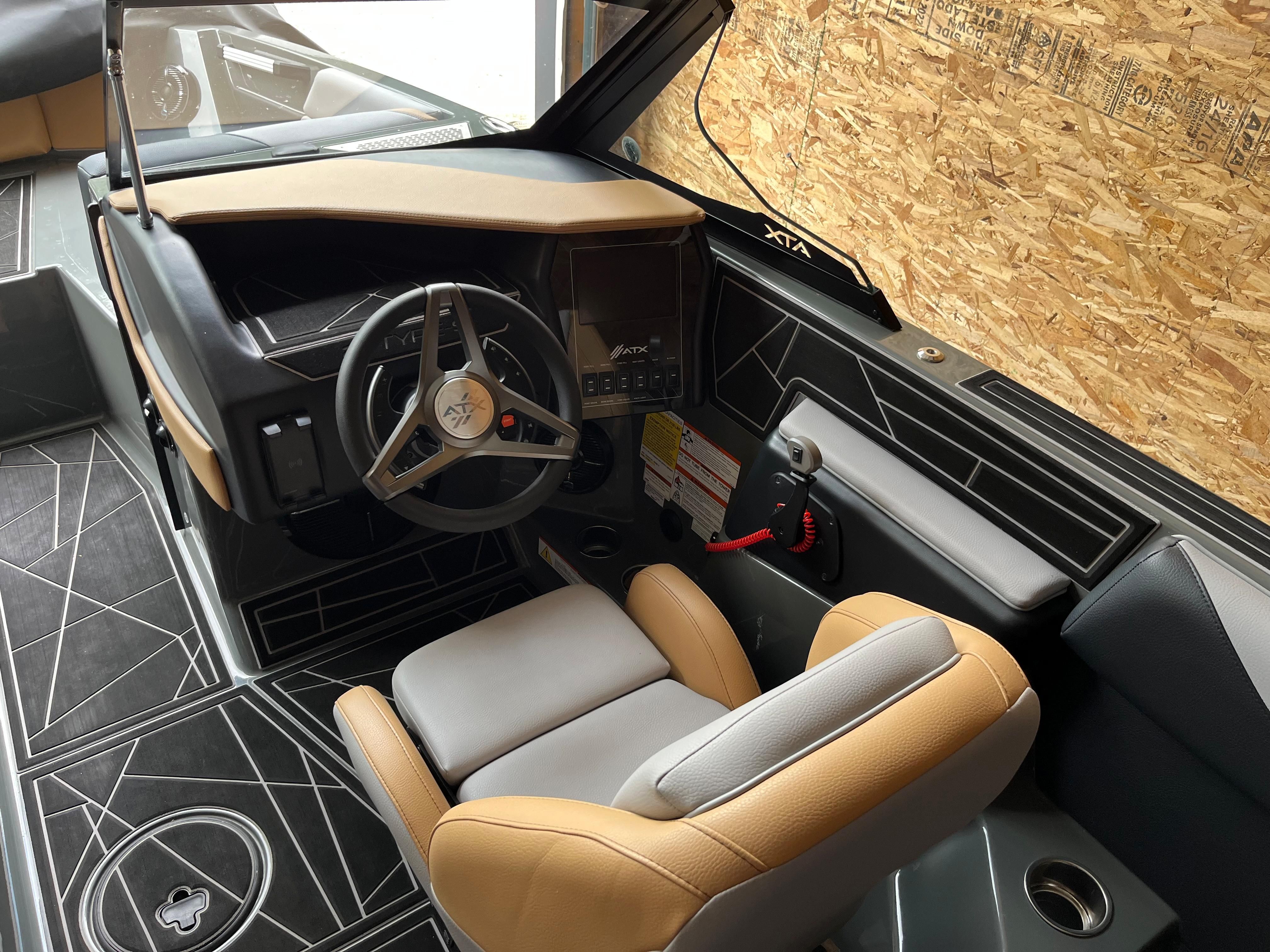 Interior of a 2022 ATX Surf Boats 22 Type-S with modern steering wheel and seating.