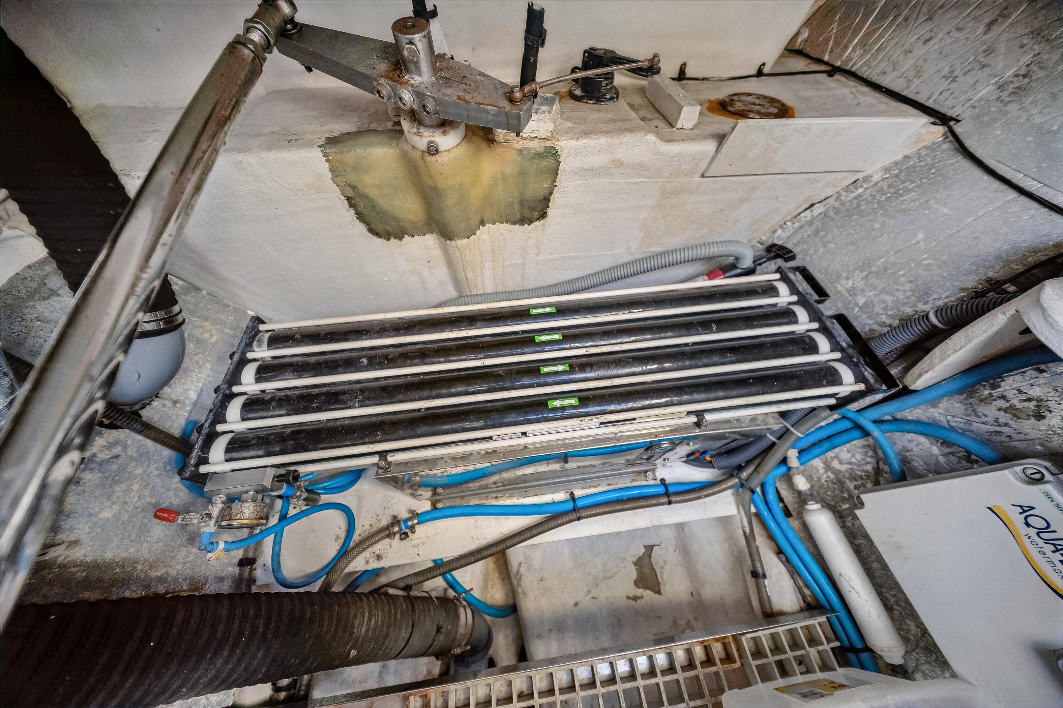 Engine room of a 2009 Catana 65 yacht, showcasing pipes and equipment.