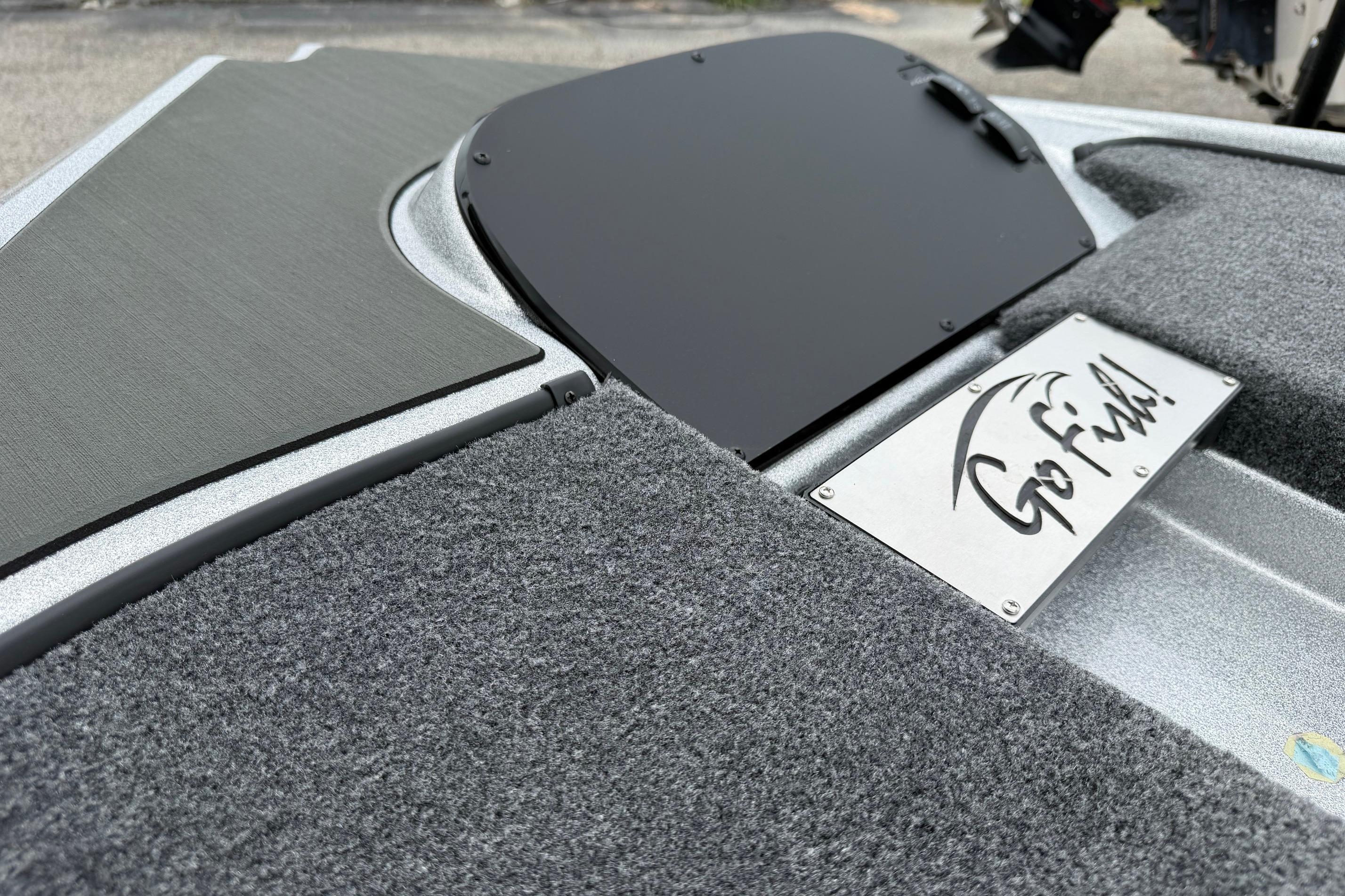 Falcon F20 PREDATOR 2027 boat deck with "Go Fish!" sign and carpeted surface.