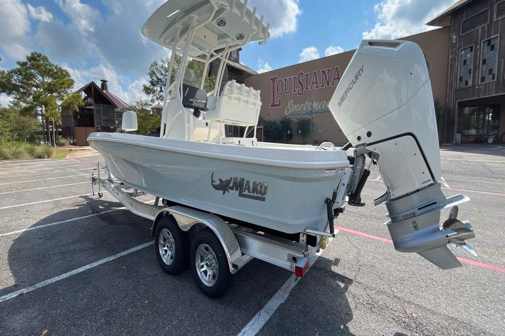 2026 Mako 24 APEX boat with Mercury engine in parking lot, Louisiana Sportsman backdrop.