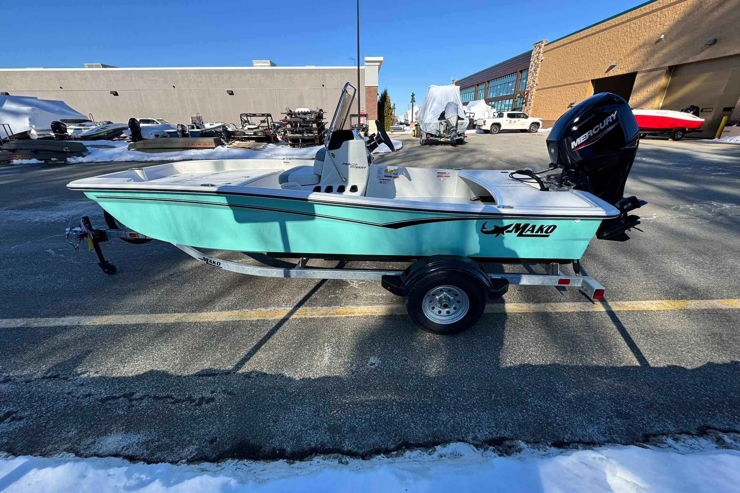 2026 Mako Pro Skiff 15 CC boat on trailer, parked outdoors.