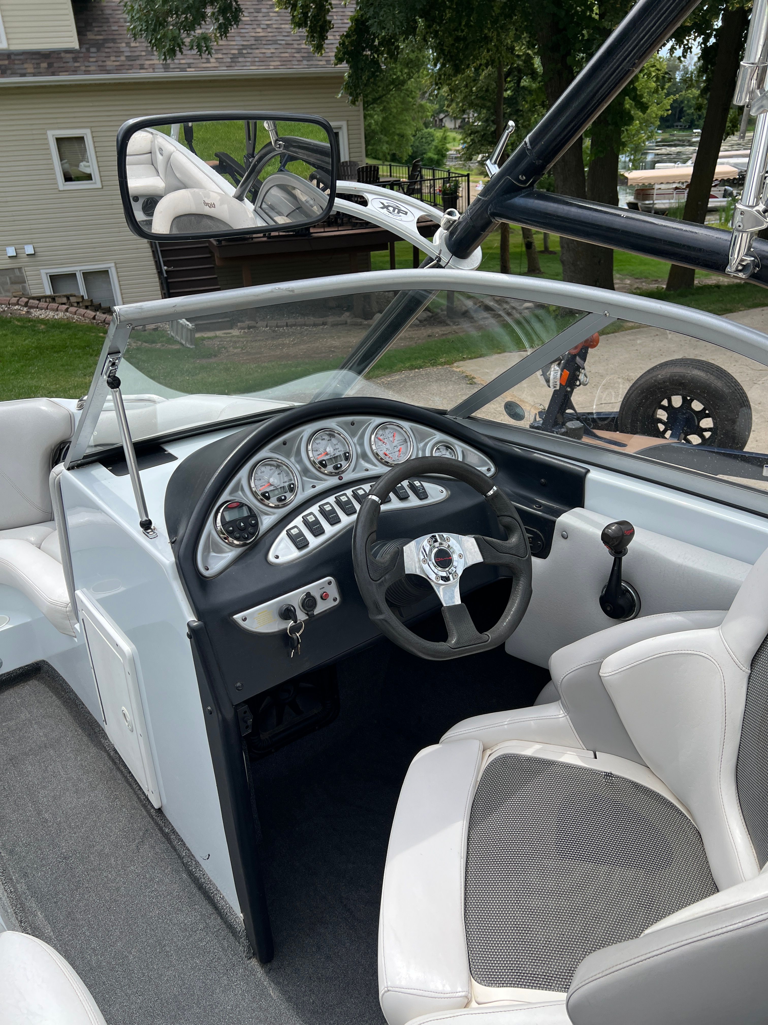 The image shows the cockpit of a 2006 Tigé 20i boat with a modern dashboard and comfortable seating.